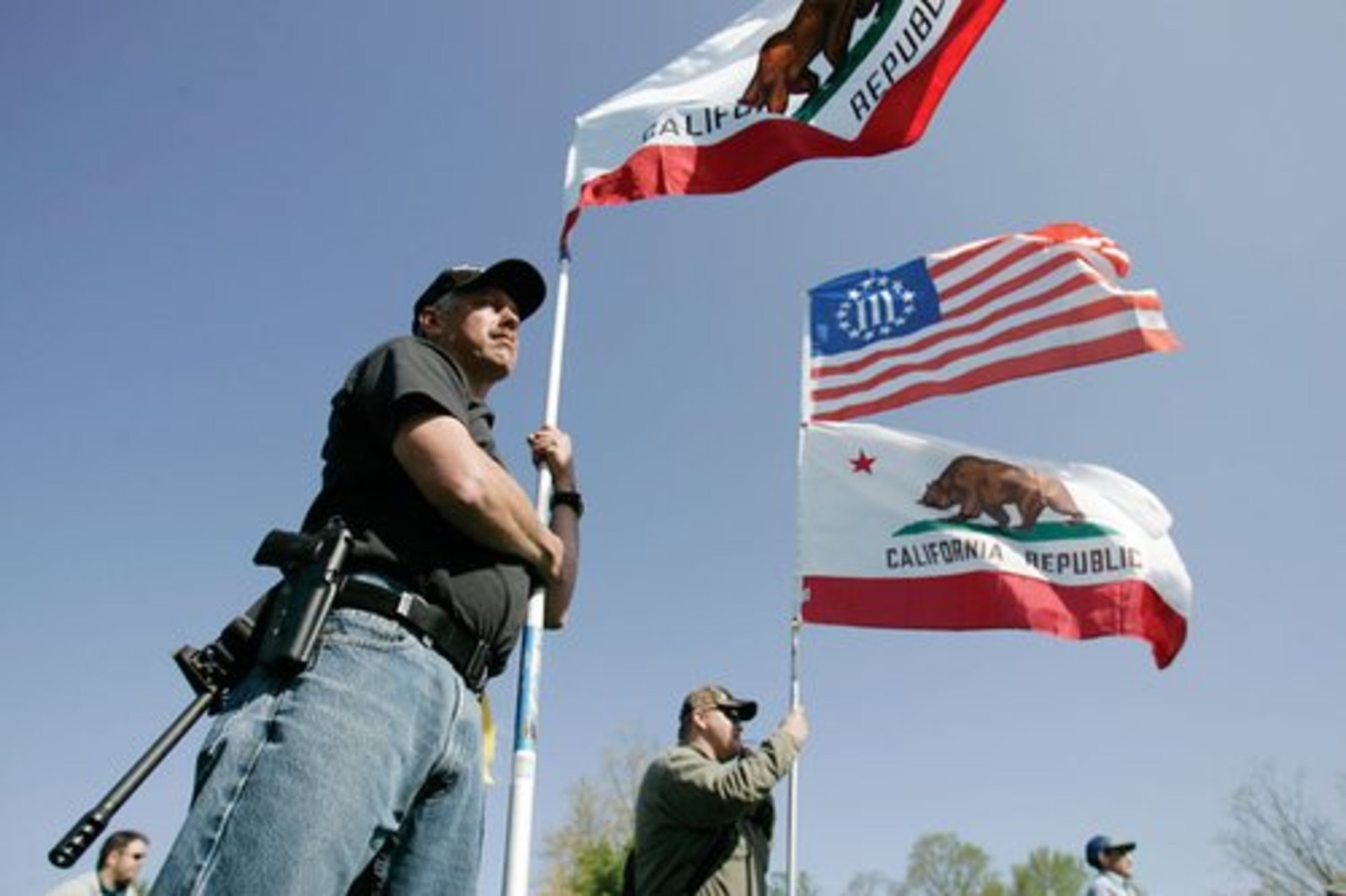 Unidentified, armed protesters from southern California join a rally for support of the Second Amendment during the "Restore the Constitution" rally at Fort Hunt Park in Alexandria, Va., on Monday, April 19, 2010.