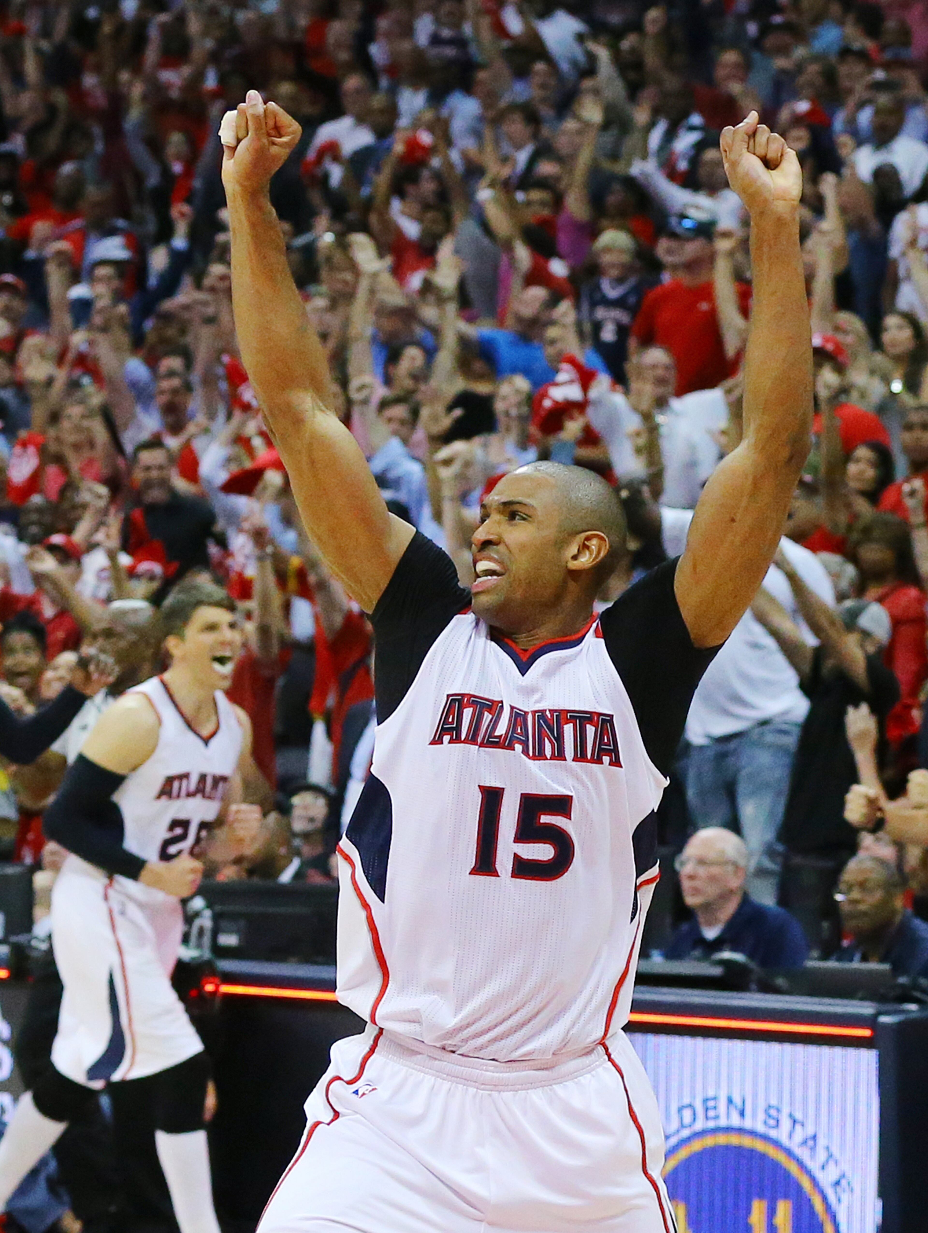 Hawks center Al Horford reacts after hitting the game winning shot to beat the Wizards 82-81 in their Eastern Conference Semifinals game 5 on Tuesday, May 13, 2015, in Atlanta. At left is teammate Kyle Korver. Curtis Compton / ccompton@ajc.com