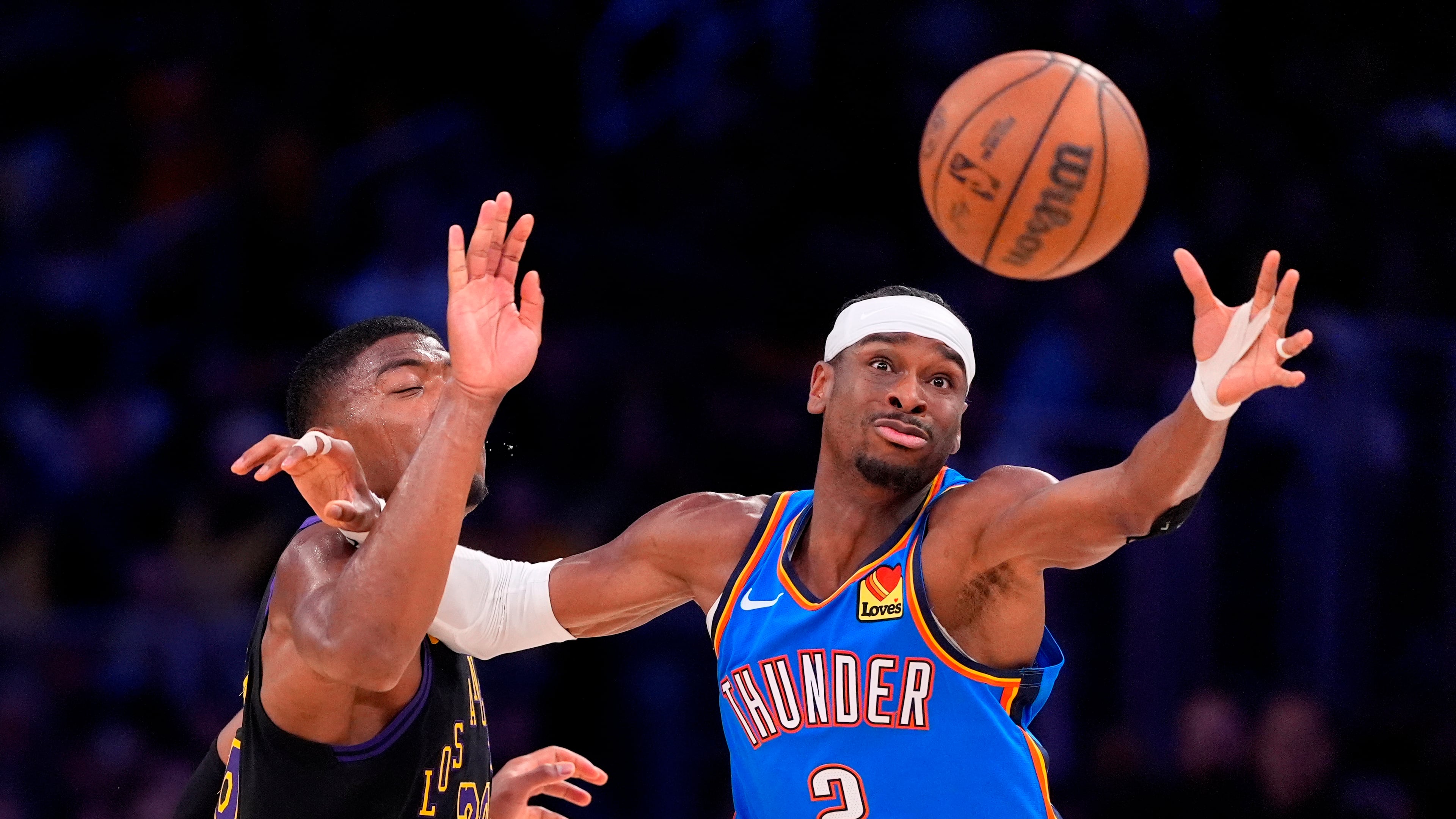Oklahoma City Thunder guard Shai Gilgeous-Alexander, right, takes a pass while under pressure from Los Angeles Lakers forward Rui Hachimura during the first half of Game 4 in a second-round NBA basketball playoffs series Monday, May 11, 2026, in Los Angeles. (AP Photo/Mark J. Terrill)