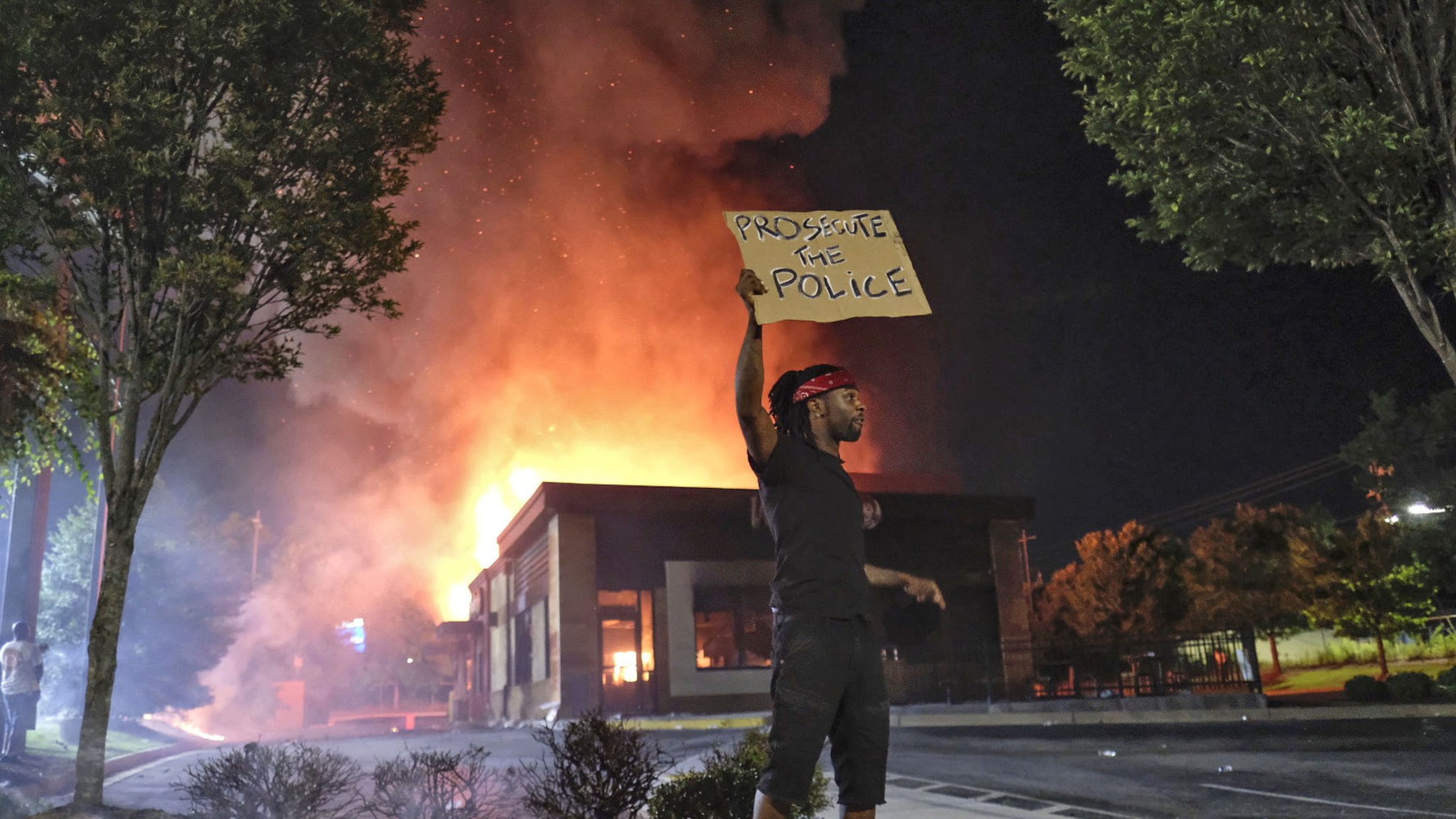 Wendy’s in flames on June 13, 2020, in southwest Atlanta after demonstrators blocked the nearby interstate and set the fast-food eatery on fire. Rayshard Brooks, a 27-year-old Black man, was shot and killed by Atlanta police the previous evening during a struggle in the Wendy’s drive-thru line. (Ben Gray for The Atlanta Journal Constitution)