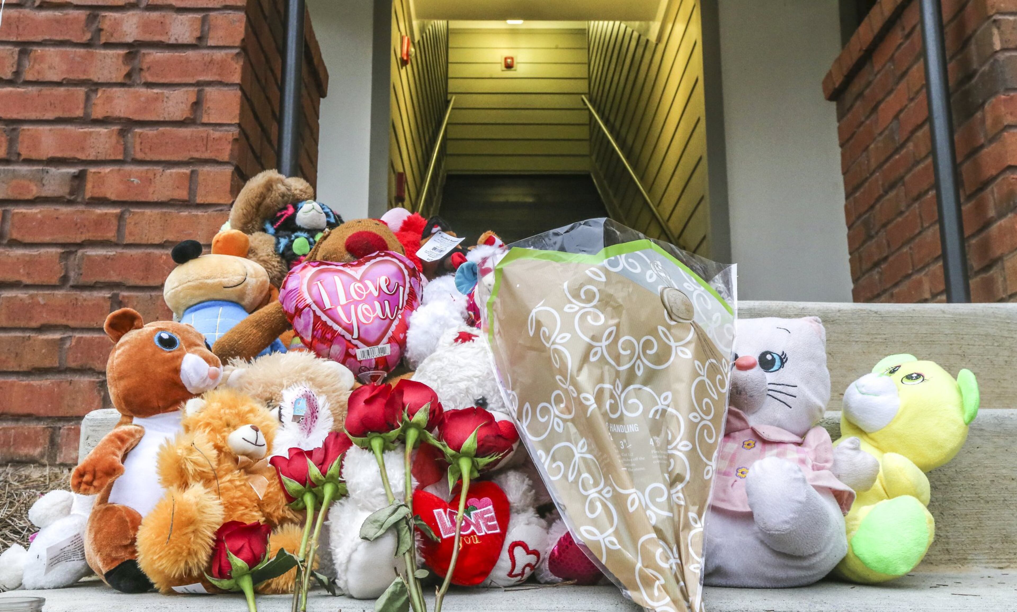 A memorial is shown in March 2018 on the steps outside the Decatur apartment where the two people were stabbed to death.