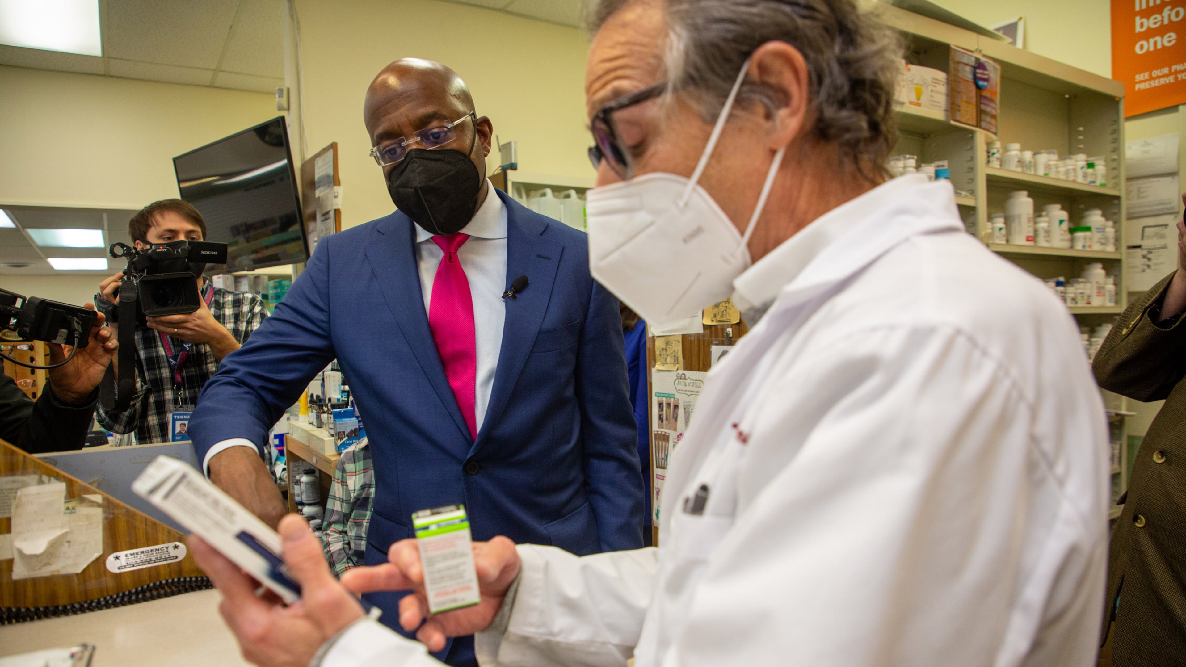 U.S. Sen. Raphael Warnock talks with pharmacist Ira Katz about his proposal to cap the price of insulin during a visit last month to the Little Five Points Pharmacy. STEVE SCHAEFER FOR THE ATLANTA JOURNAL-CONSTITUTION