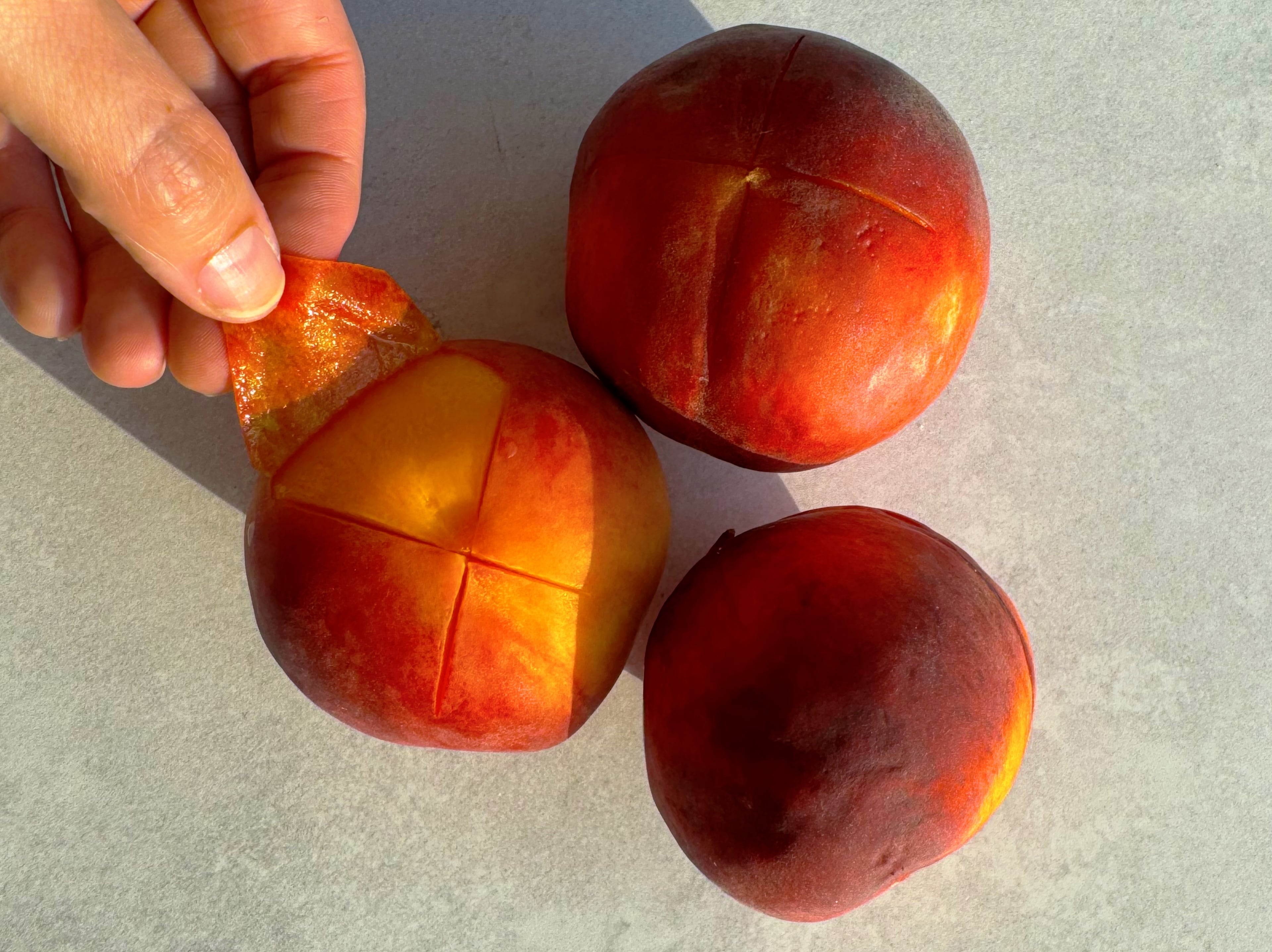 The easiest way to peel peaches is by using the blanch and shock method, which makes the skins slide right off. (Monti Carlo/AJC)