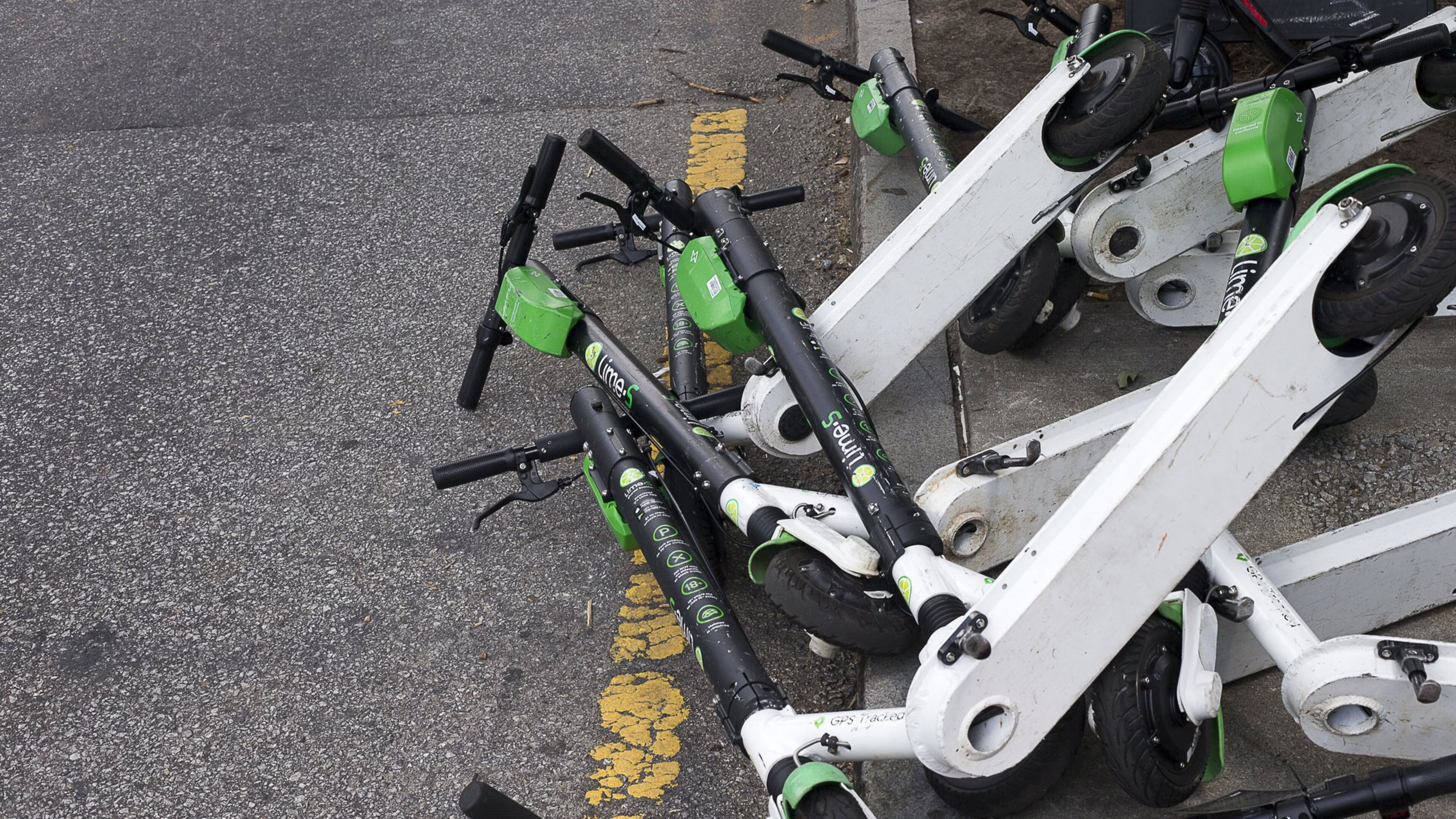 Sharable e-scooters lay knocked in a lane along Centennial Olympics Park Drive NW near Centennial Olympic Park Atlanta. (Alyssa Pointer/alyssa.pointer@ajc.com)