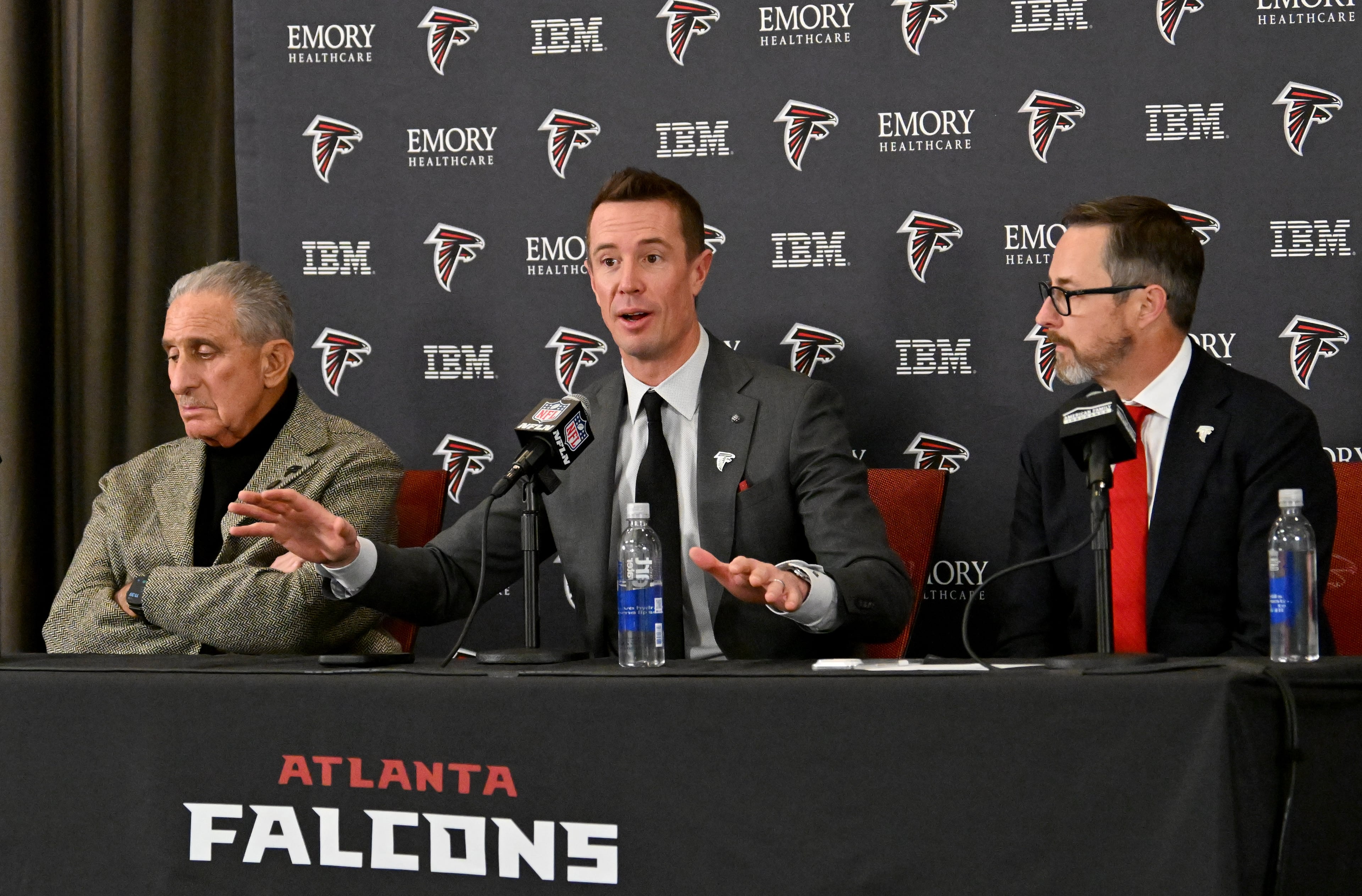 New Atlanta Falcons president of football Matt Ryan (center) speaks as Atlanta Falcons owner Arthur M. Blank (left) and CEO Greg Beadles sit next him during a news conference to introduce new Falcons president of football Matt Ryan, Tuesday, Jan. 13, 2026, in Flowery Branch. (Hyosub Shin/AJC)