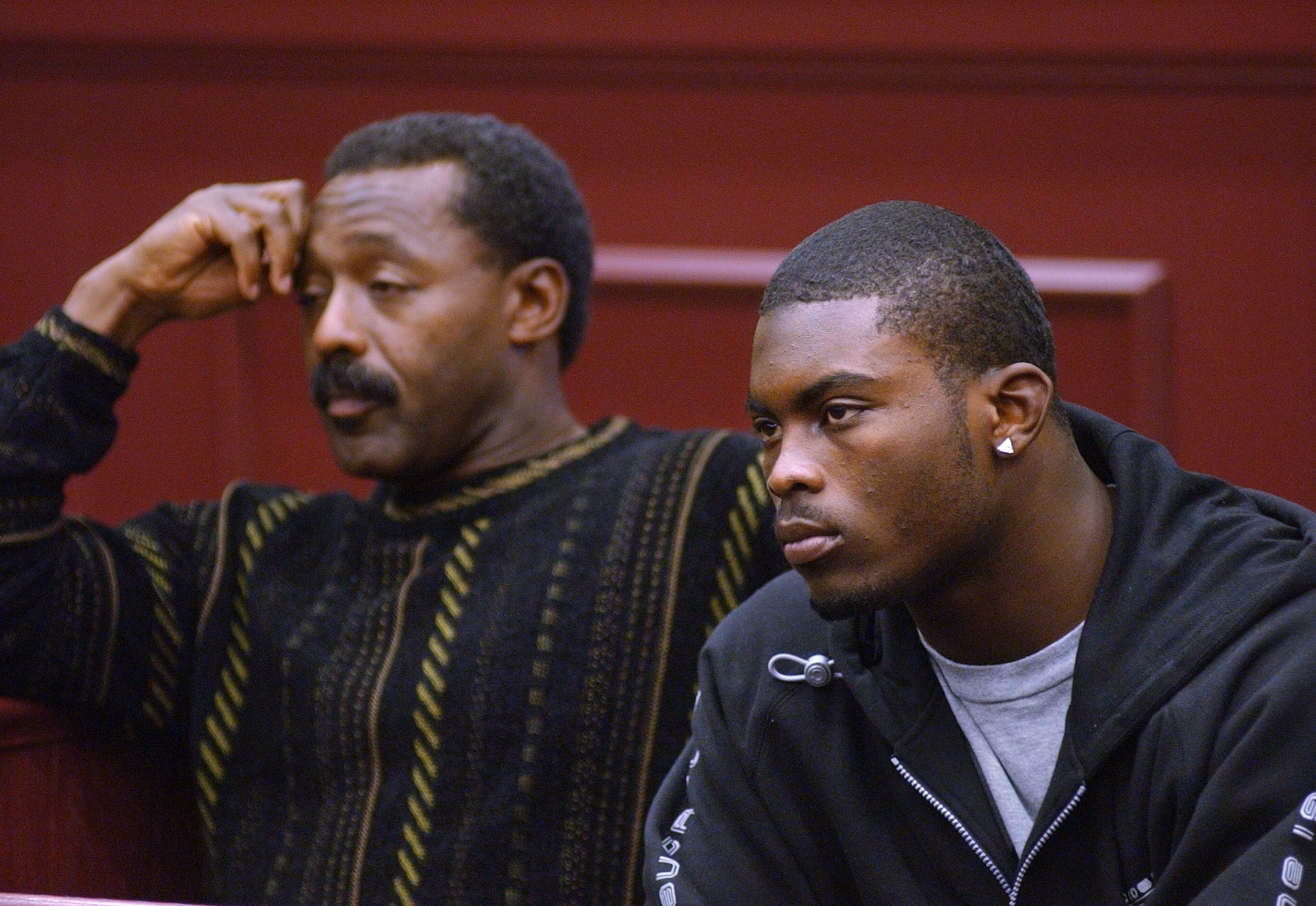 Falcons front office executive Billy Johnson (left) accompanies Michael Vick in court in Clayton County in 2002. Vick was there due to citations he received. AJC file photo