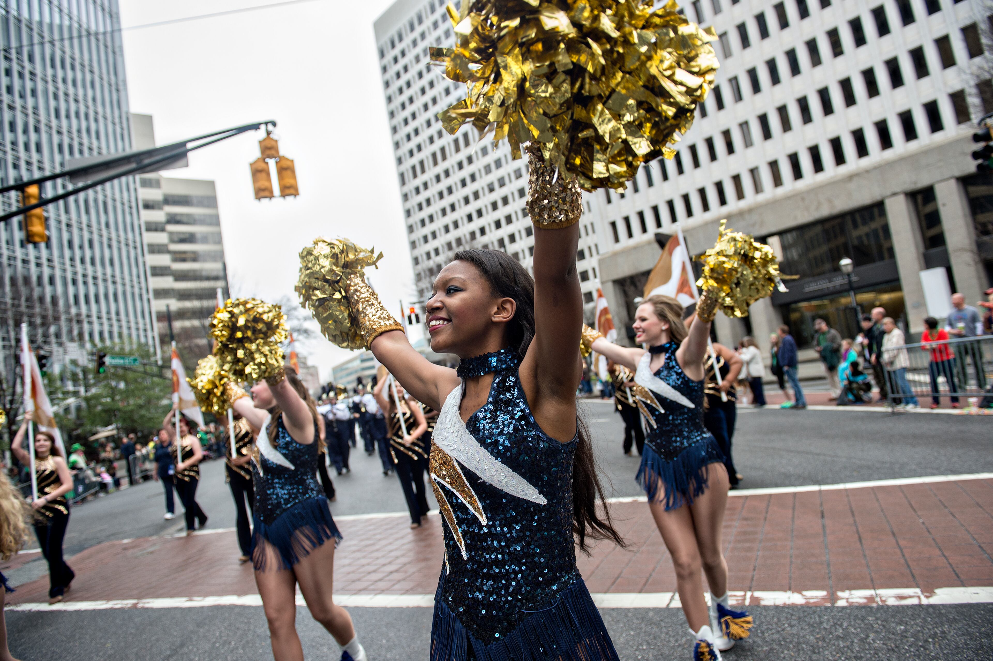 Shatoya Teague (center) marches down Peachtree Street during the 2015 Atlanta St. Patrick's Parade on Saturday, March 14, 2015. Thousands of people attend the parade which dates back to 1858. JONATHAN PHILLIPS / SPECIAL