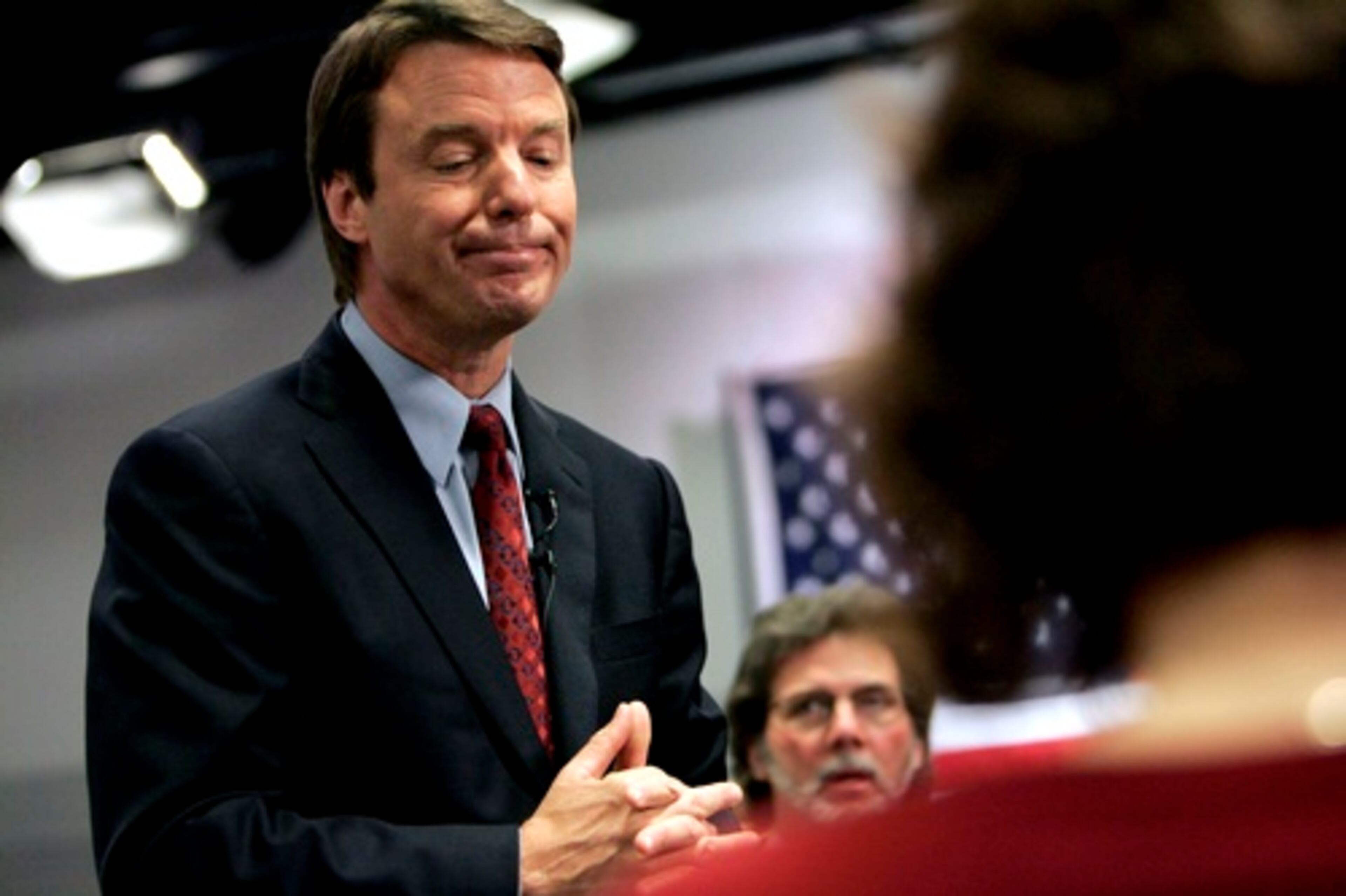 Edwards answers questions from the press after speaking at the New Hampshire Institute of Politics at Saint Anselm College in Manchester March 15, 2007.