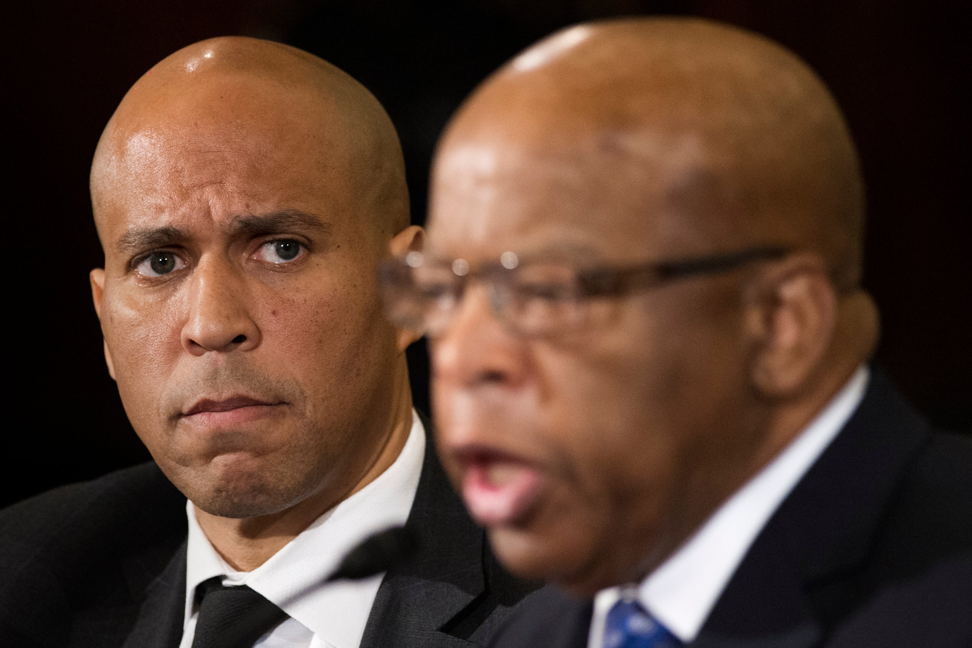 A 2017 file photo of U.S. Sen. Cory Booker (left) and U.S. Rep. John Lewis, who died in 2020. Booker invokes Lewis early in his new book, "Stand." (Cliff Owen/AP)