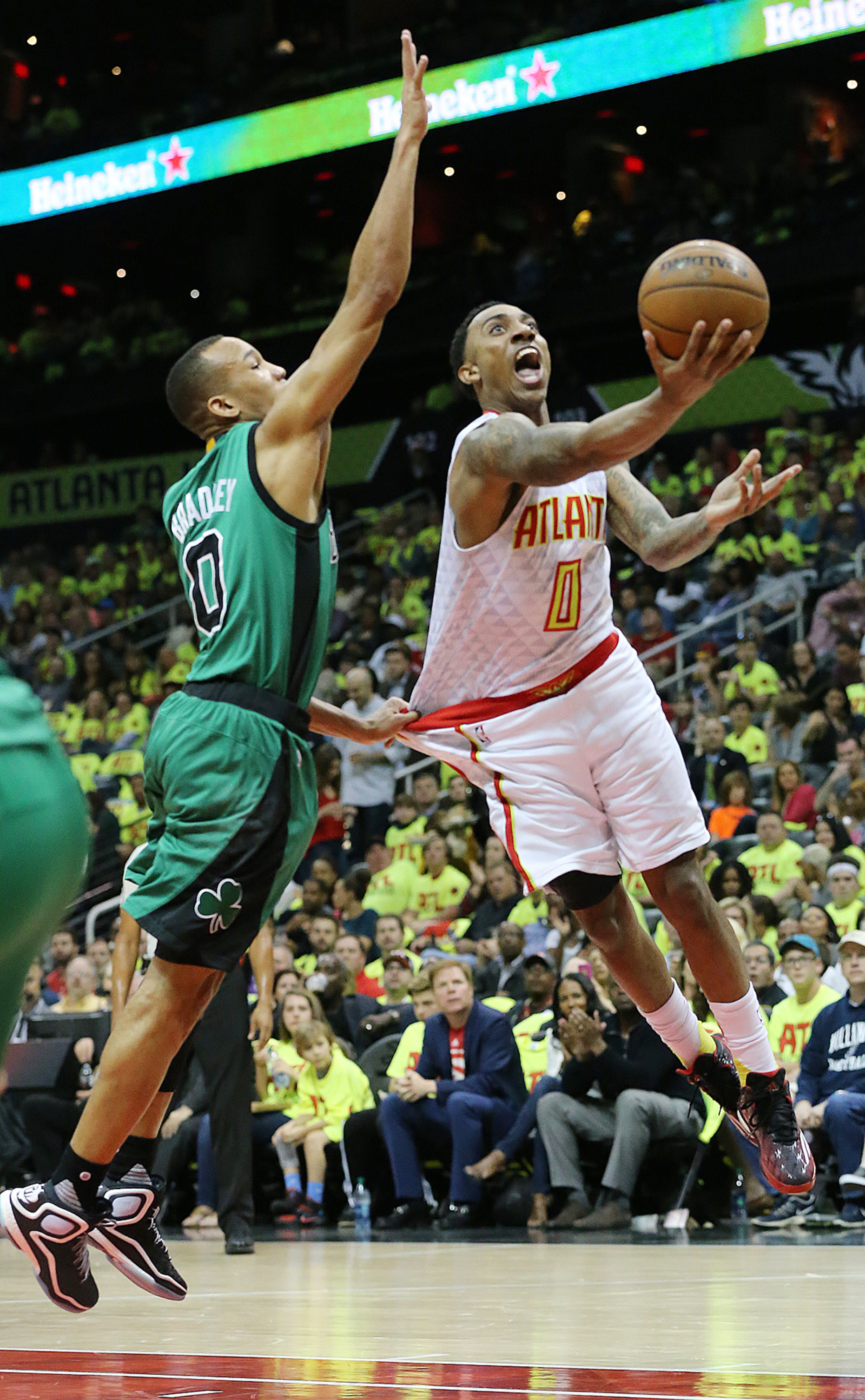041616 ATLANTA: Hawks guard Jeff Teague goes to the basket for two points against Celtics guard Avery Bradley despite a handful of shirt in their first NBA Playoff basketball game at Philips Arena on Saturday, April 16, 2016. Curtis Compton / ccompton@ajc.com