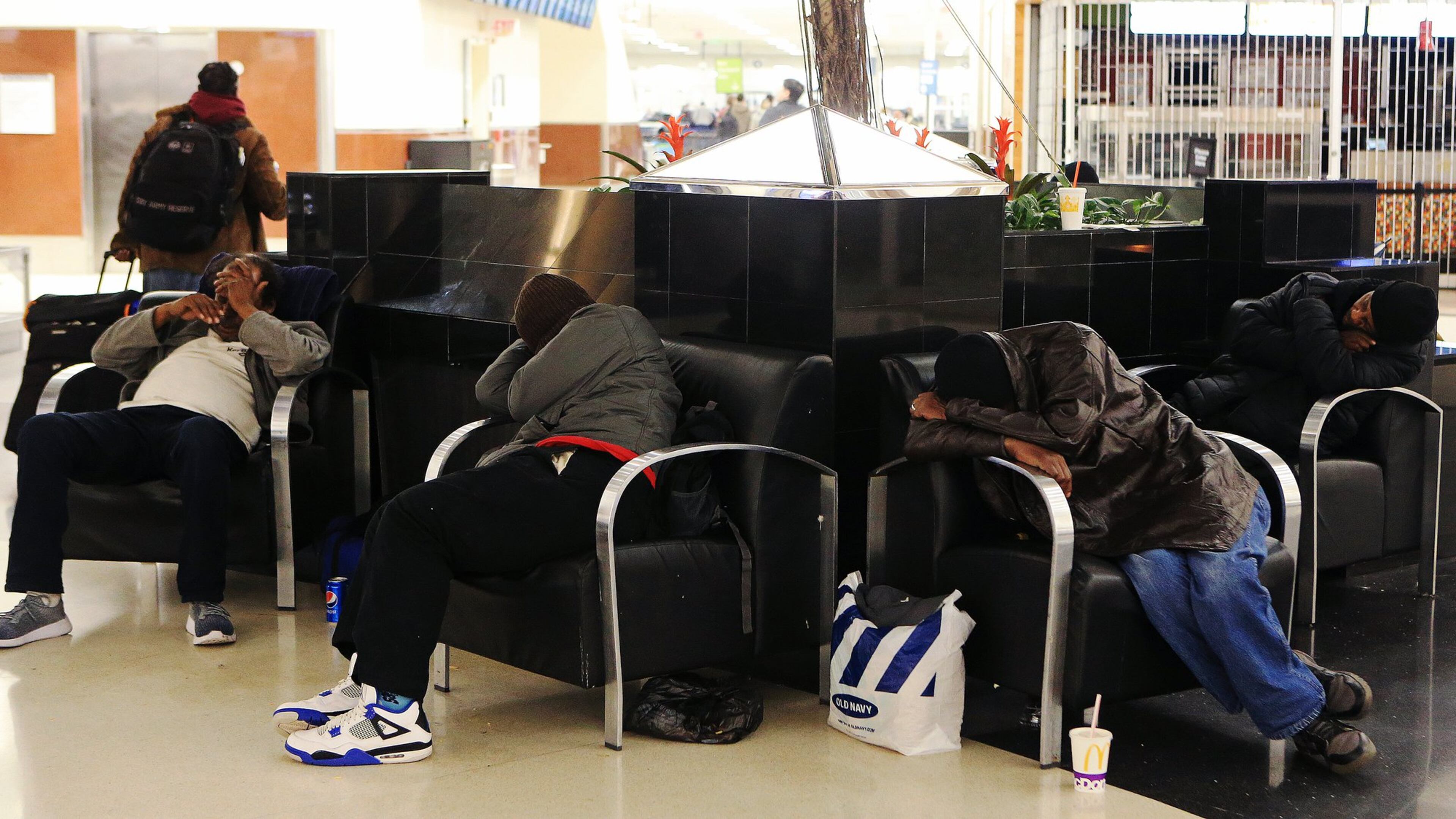 Men sleep in the domestic terminal of Hartsfield-Jackson International Airport on Friday, February 7, 2020, in Atlanta. Many of Atlanta’s homeless sleep overnight in the airport’s domestic terminal when the city experiences frigid temperatures. (Christina Matacotta/crmatacotta@gmail.com)