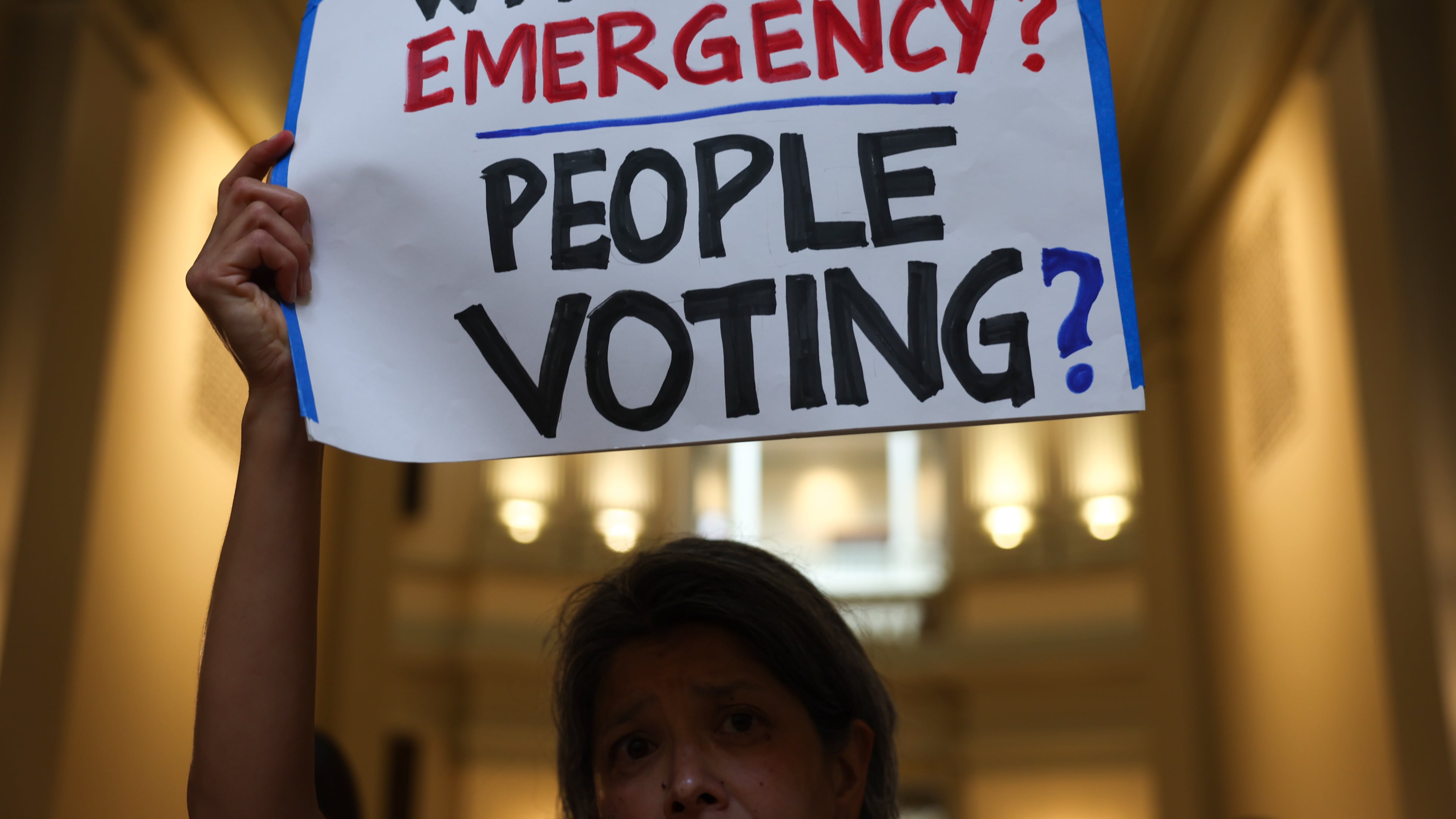 Activists gather at a news conference before the state Legislature convenes for a special session in June. (Arvin Temkar/AJC)