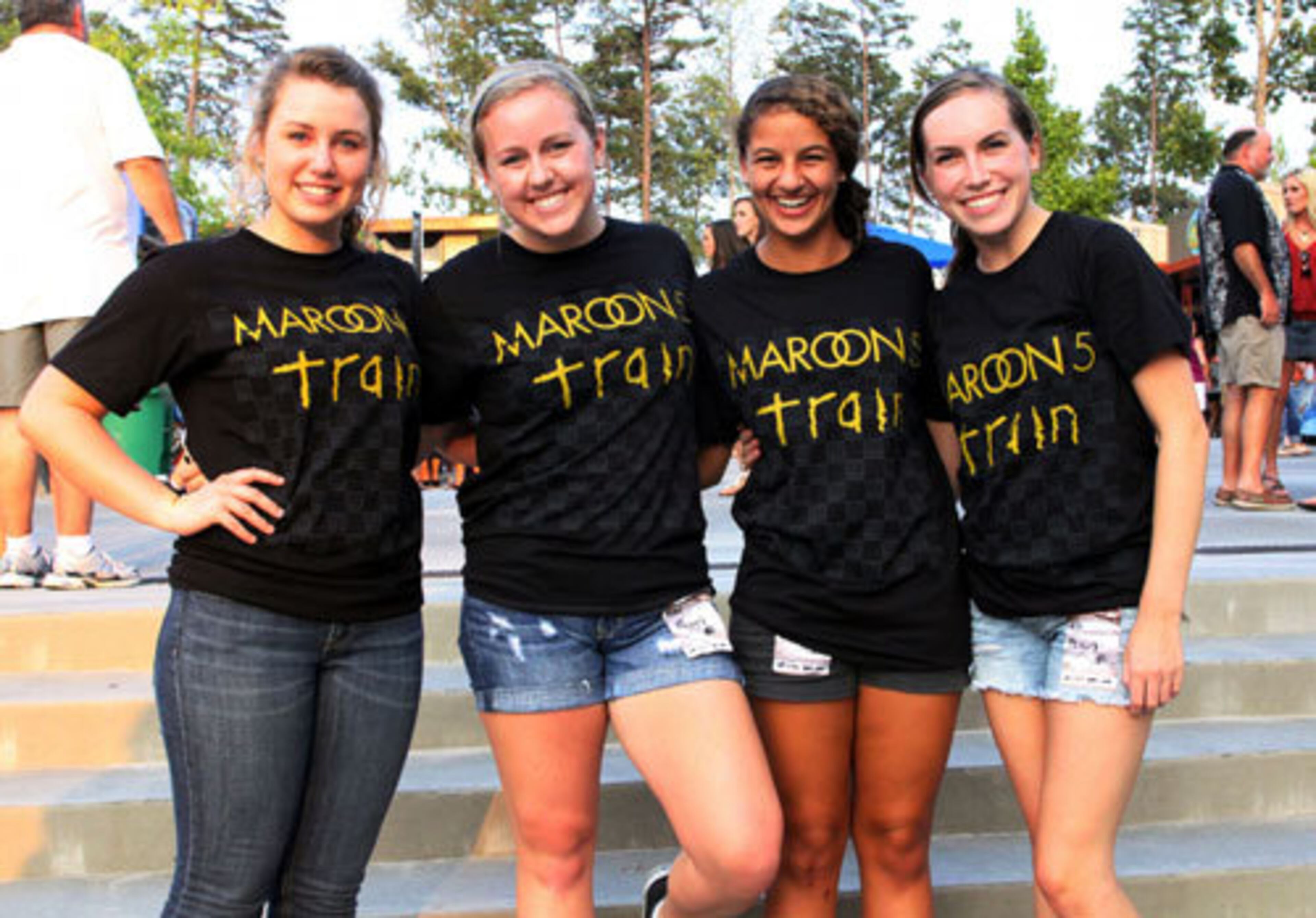 Rachel Veniez, left, Mallory Weaver, Kamilah Talbi and Lauren Blessing from Lawrenceville show off their matching Maroon 5/Train T-shirts.