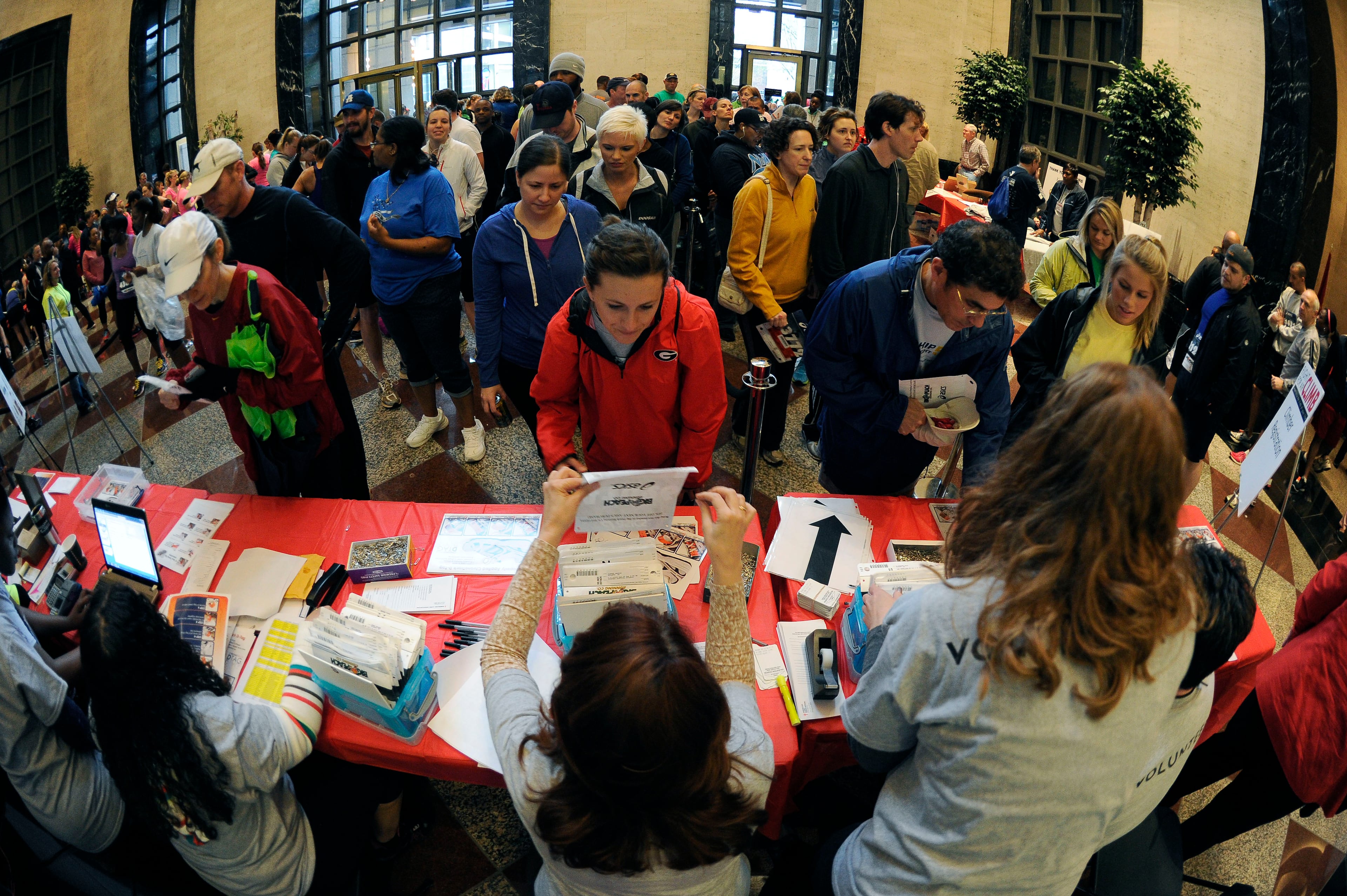Caroline Poirer, center, joins over 600 stair climbers registering for their race to the top of One Ninety One Peachtree Tower where climbers ascended 51 flights of stairs inside the city's third tallest building at the American Lung Association's Fight for Air Climb on Saturday, April 19, 2014.
