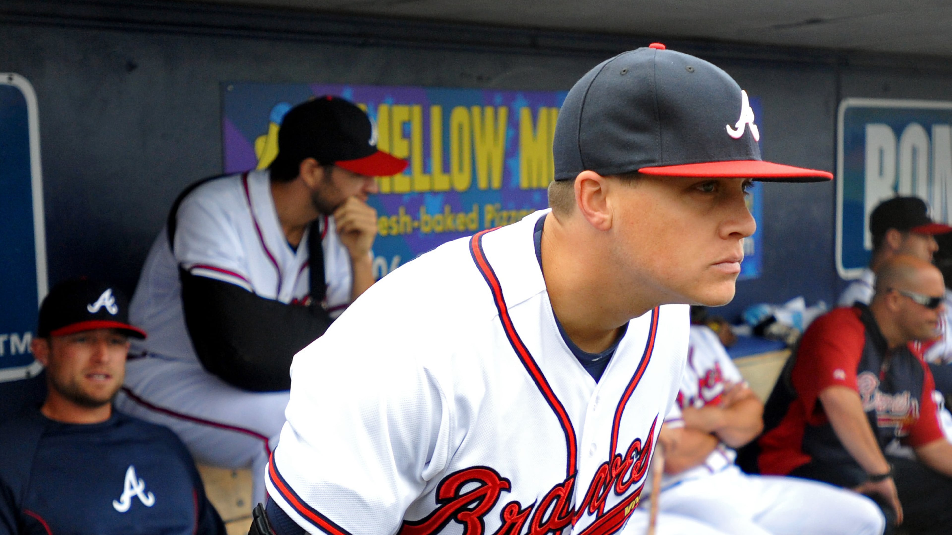 Atlanta Braves pitcher Kris Medlen wears an elbow brace on his right arm after season-ending Tommy John surgery as he waits during a rain delay in their exhibition baseball game against the team's minor league Future Stars Saturday, March 29, 2014, in Rome, Ga. (AP Photo/David Tulis)