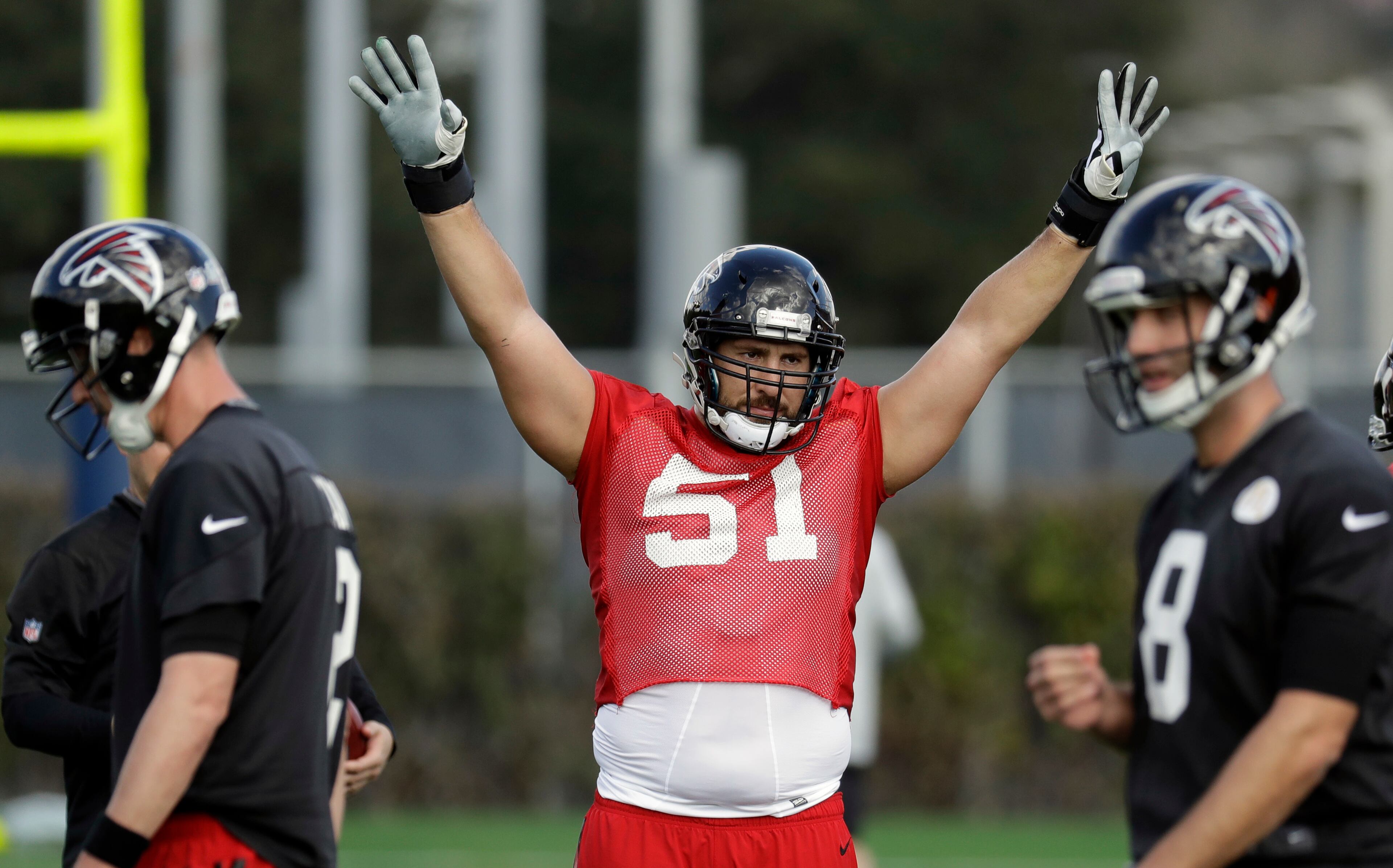 Atlanta Falcons center Alex Mack (51) signals to teammates during a practice for the NFL Super Bowl 51 football game Wednesday, Feb. 1, 2017, in Houston. Atlanta will face the New England Patriots in the Super Bowl Sunday. (AP Photo/Eric Gay)