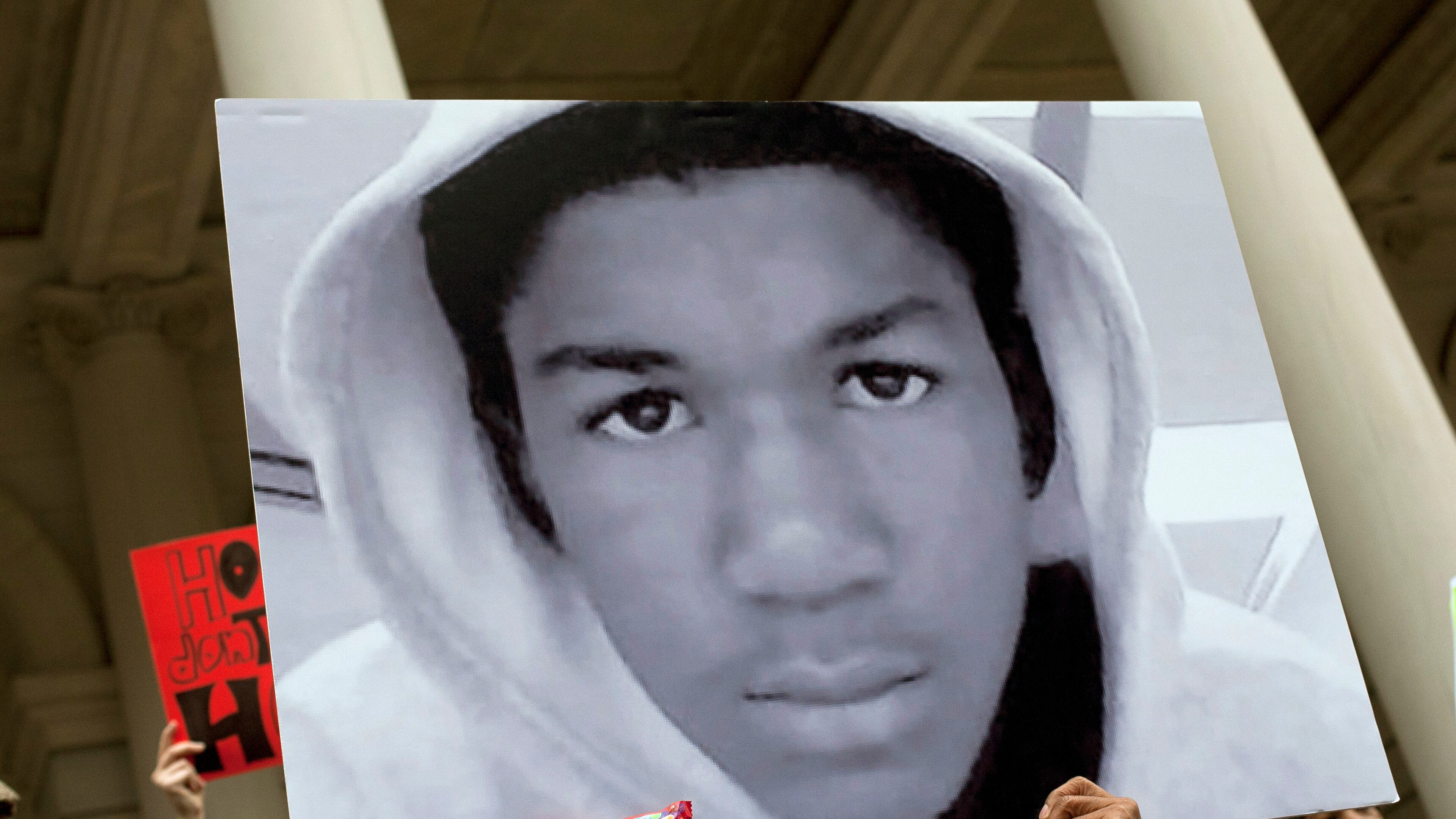 NEW YORK, NY - MARCH 28: People along with New York City Council members attend a press conference to call for justice in the February 26 killing of 17-year-old Trayvon Martin in Sanford, Florida, on the steps of City Hall March 28, 2012 in New York City. Martin was killed by George Michael Zimmerman while on neighborhood watch patrol in the gated community of The Retreat at Twin Lakes. (Photo by Allison Joyce/Getty Images)