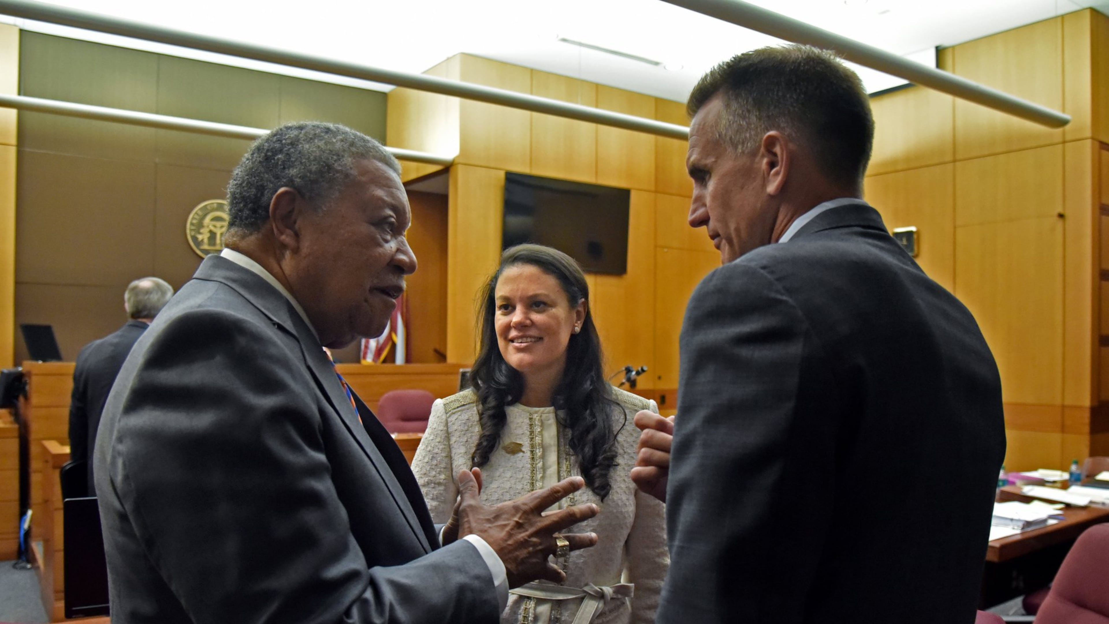 Robb Pitts (left), chairman of Fulton County Board of Commissioners, celebrates with Meria Carstarphen, superintendent of Atlanta Public Schools, and Jeff Rose (right), superintendent of Fulton County Schools, after a judge ruled on Aug. 14 that Fulton County could collect tax money. HYOSUB SHIN / HSHIN@AJC.COM