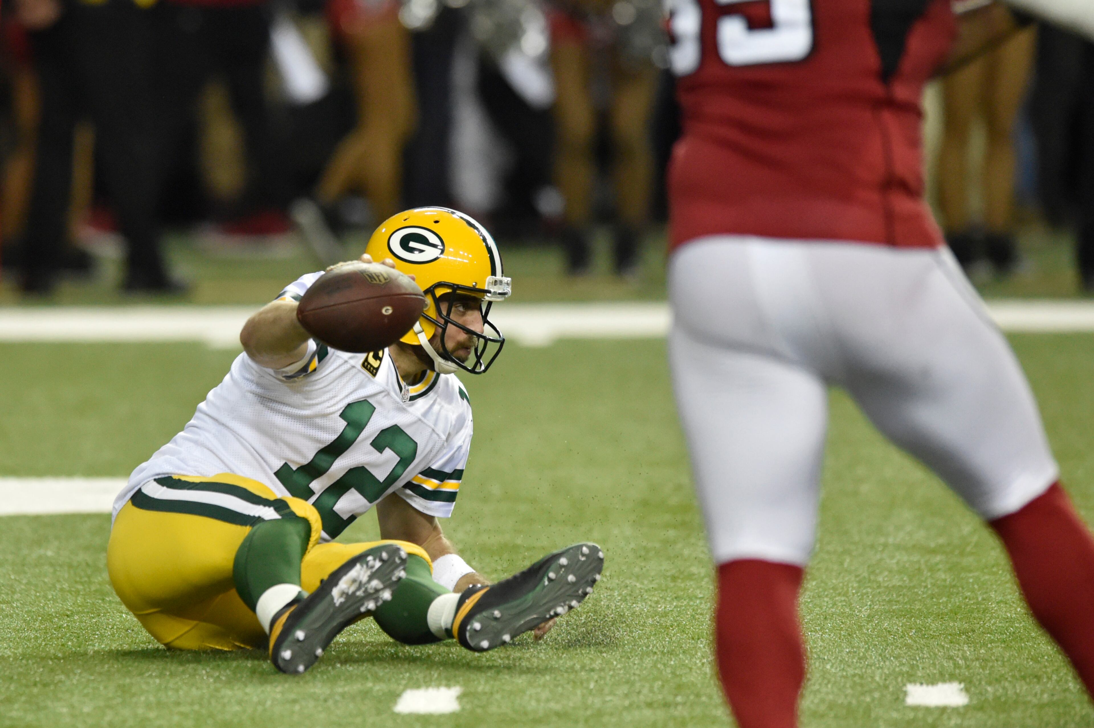 January 22, 2017, Atlanta - Packers quarterback Aaron Rodgers (12) falls backwards during the NFC Championship game against the Packers in Atlanta, Georgia, on Sunday, January 22, 2017. (DAVID BARNES / DAVID.BARNES@AJC.COM)