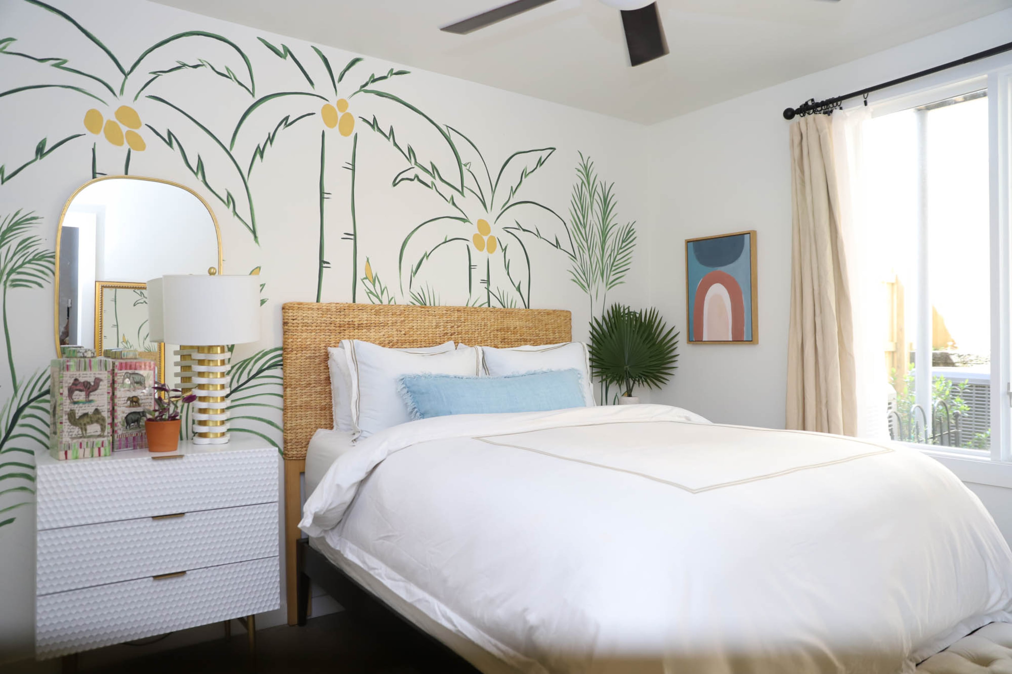 The guest bedroom of Mary O’Gara’s Atlanta townhome is airy and tropical, with a palm tree mural on one wall by Mary’s son, Kevin O’Gara of Kevin Francis Design. When Mary decided she didn’t like the gray wallpaper in the space after she moved in last year, Kevin offered to do something fresh and fun, and the palm tree mural was the product. Furniture from At Home finishes the space. Text by Shannon Dominy/Photo by Reynolds Rogers