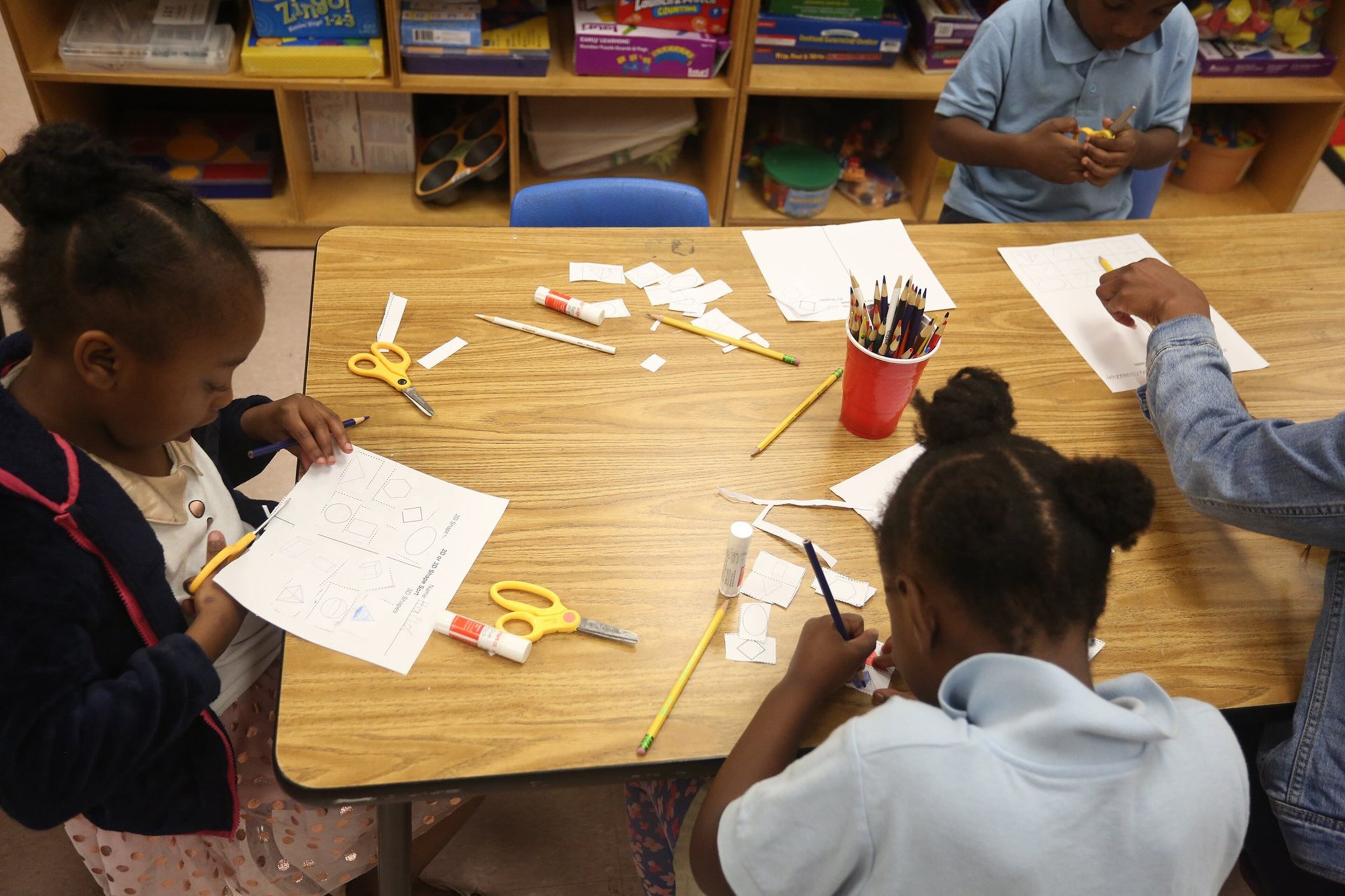 Kindergarten student Hailey Hubbard cuts out shapes during class.