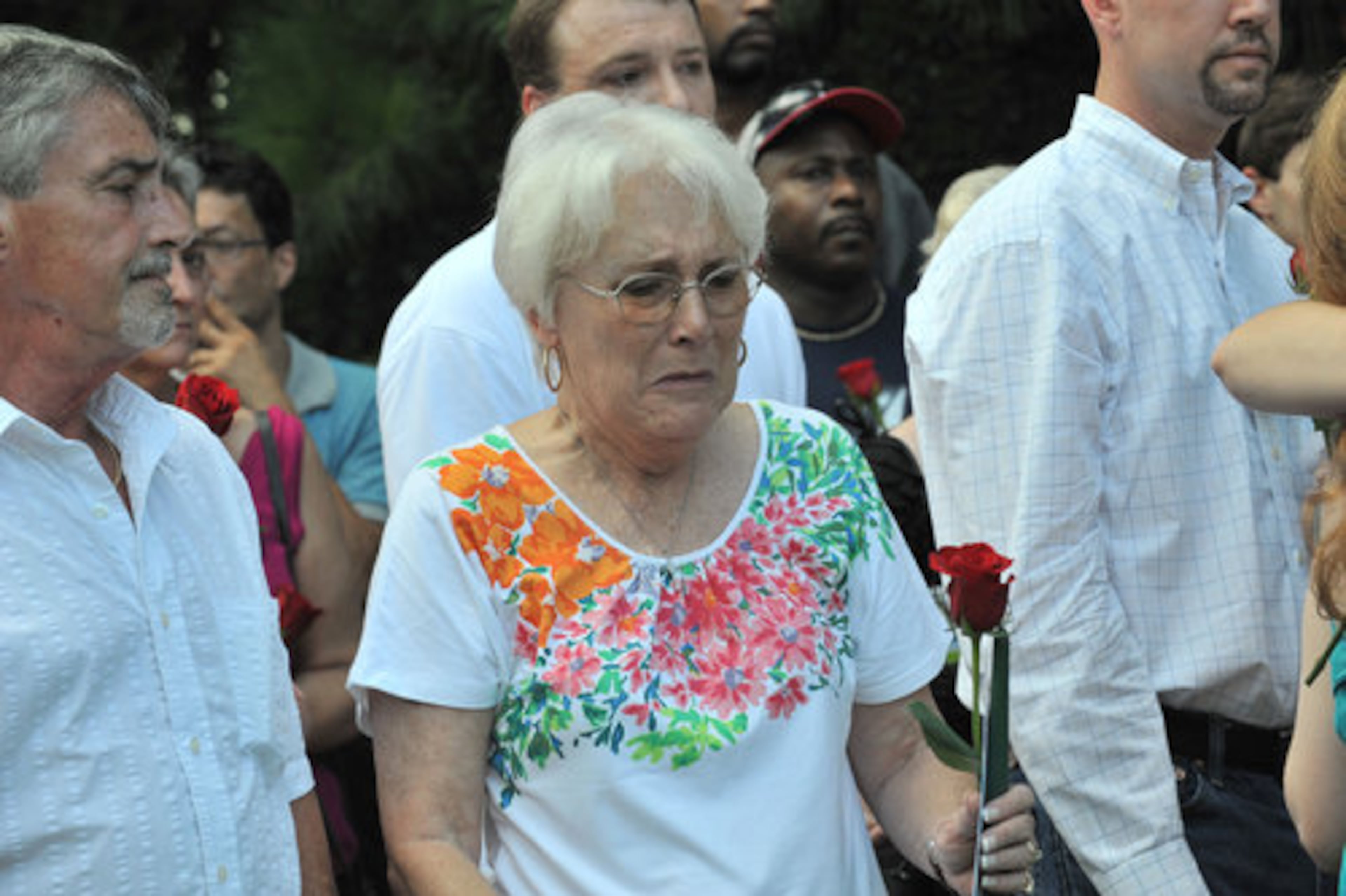 Harriett Garrett (center), the mother of Nique Leili, cries during the candlelight vigil Friday night for her daughter, whose body was discovered Saturday morning in the Oak Village subdivision in Lawrenceville.