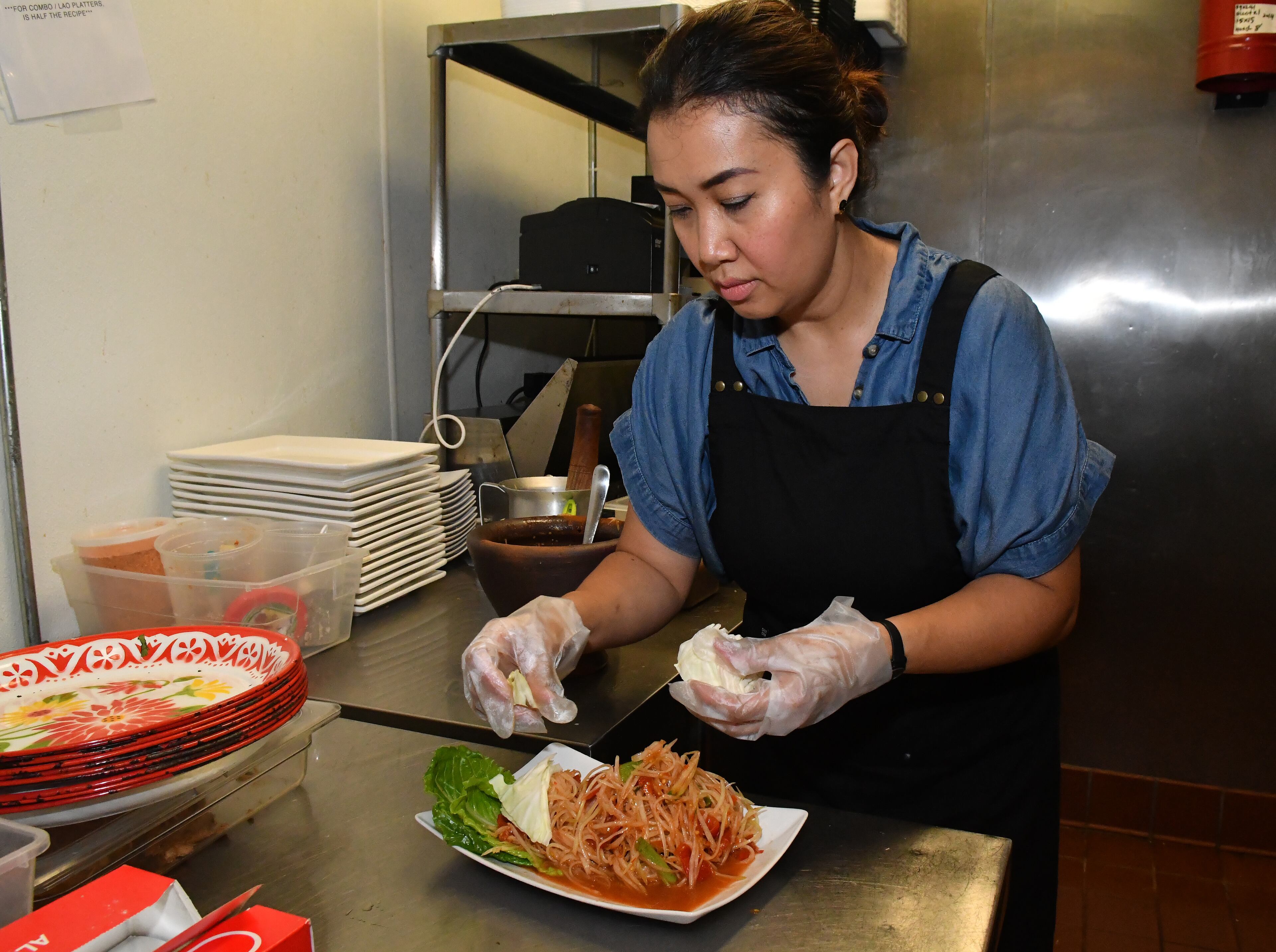 Chef Thip Athakhanh prepares traditional Laotian papaya salad at Snackboxe Bistro. Chris Hunt for The Atlanta Journal-Constitution