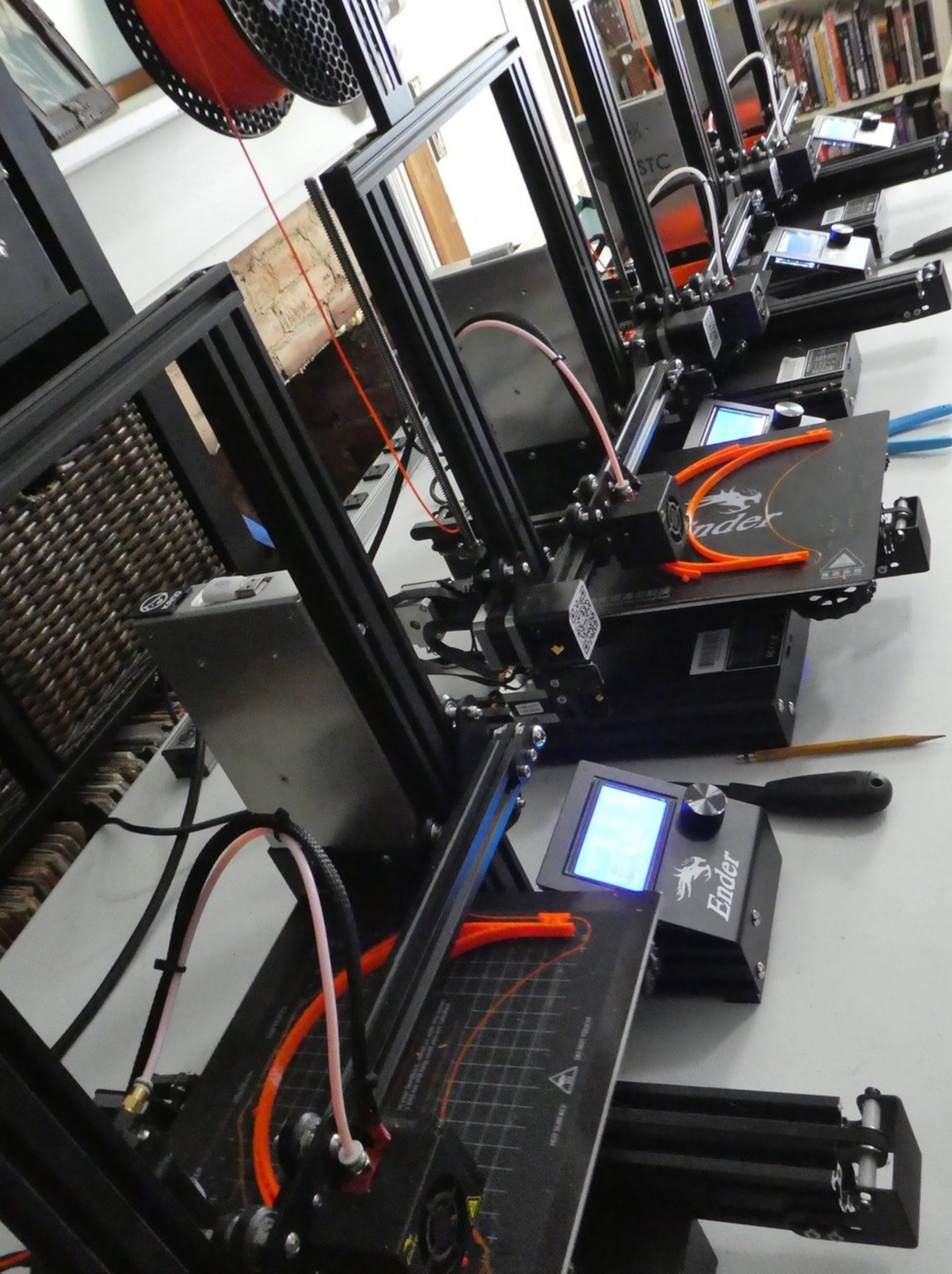 A line of 3D printers at work in the Sugiuchi home. Contributed by Deirdre Sugiuchi