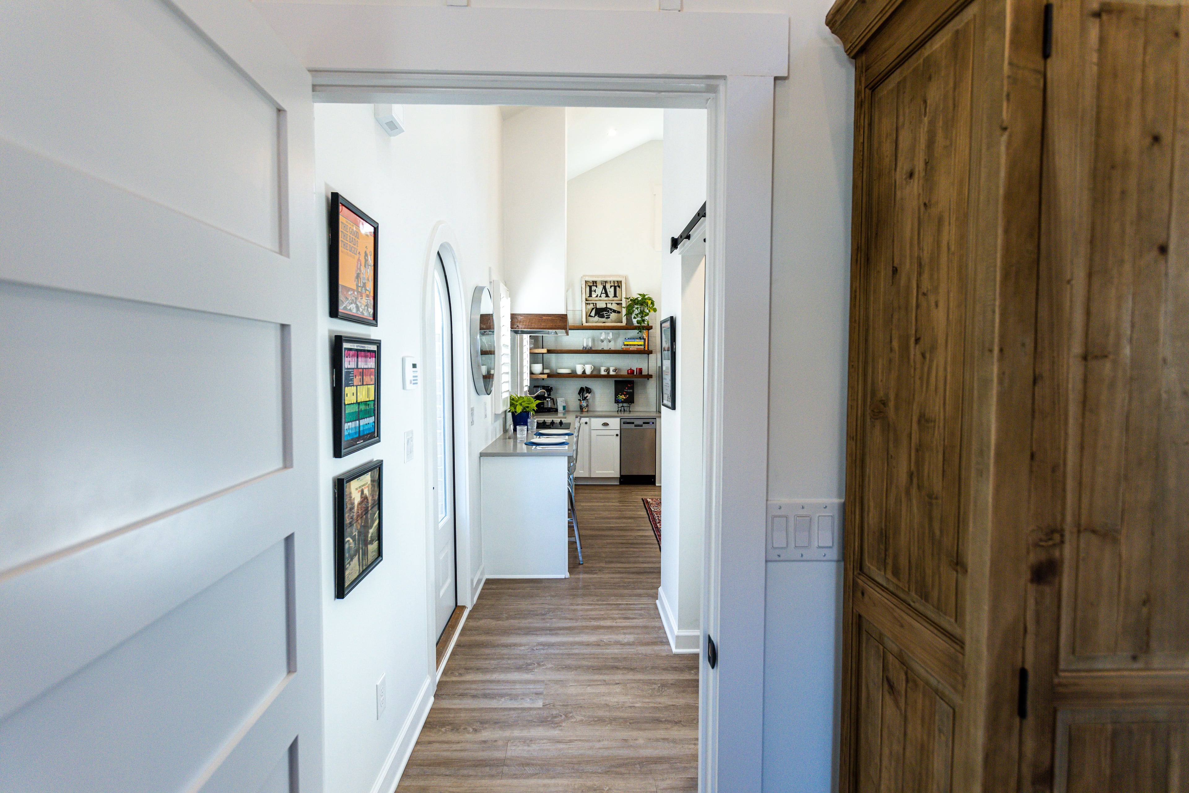 View from the hallway reveals a custom armoire and framed Bob Dylan vinyl albums on the walls. Text by Mike Rieman