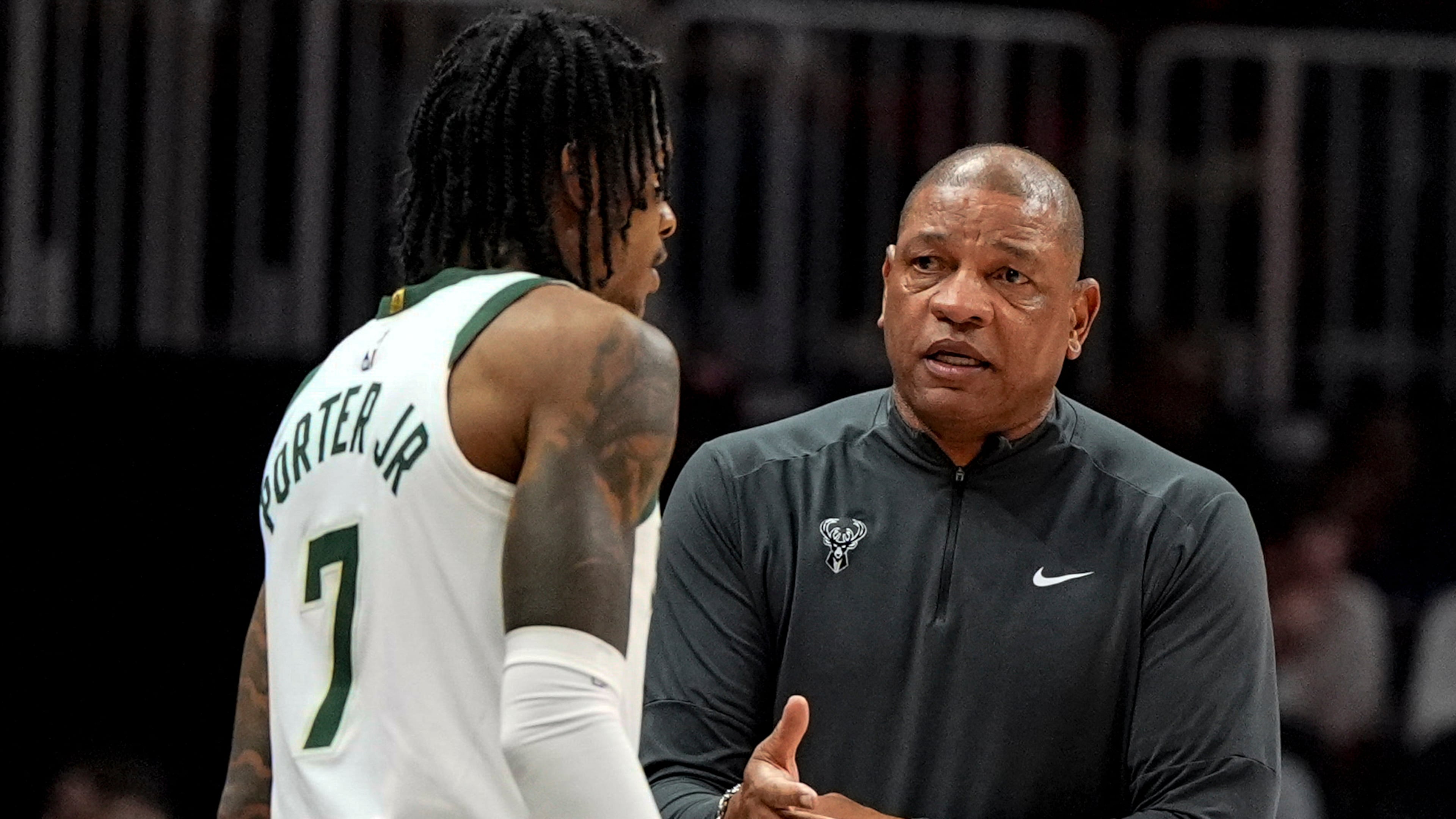 Milwaukee Bucks head coach Doc Rivers speaks to Kevin Porter Jr. (7) during the first half of an NBA basketball game against the Atlanta Hawks, Saturday, March 14, 2026, in Atlanta. (AP Photo/Mike Stewart)