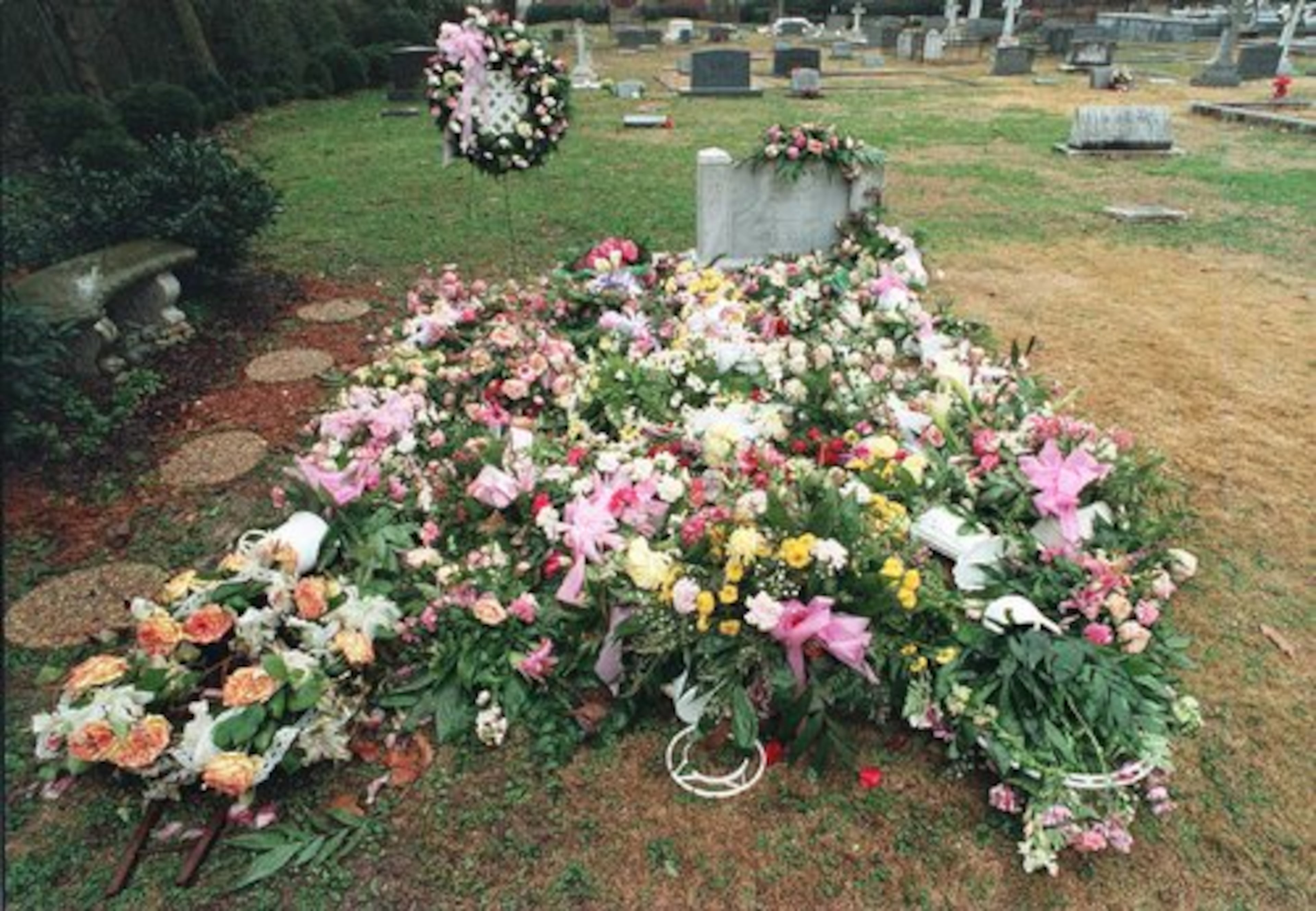 The gravesite of JonBenet Ramsey is shown covered with numerous flowers Wednesday afternoon in January 1997 at St. James Episcopal Cemetary in Marietta.