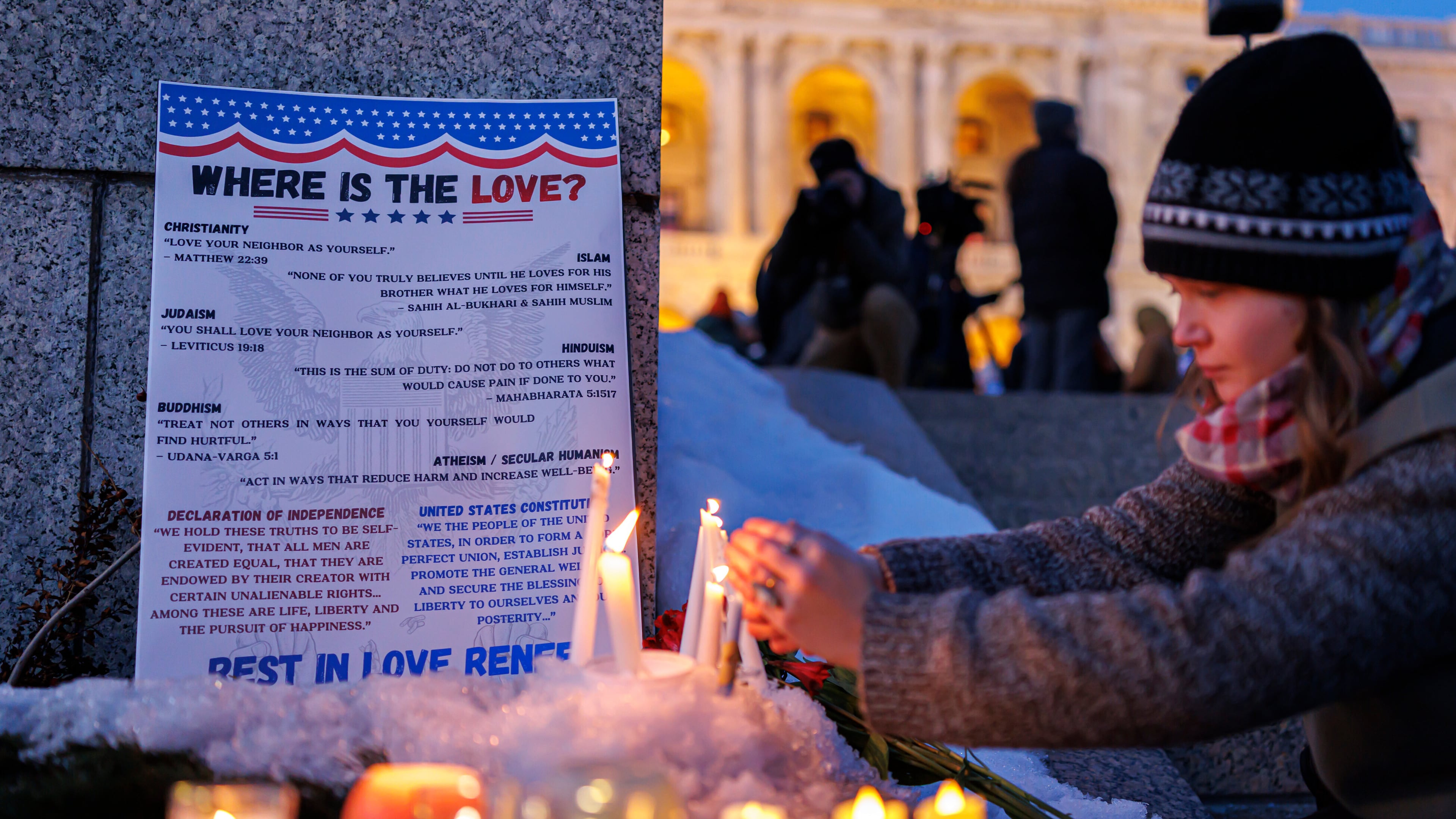 Candles burn around a poem written by Renee Good during a vigil honoring her on Friday, Jan. 9, 2026, in St. Paul, Minn., outside the Minnesota State Capitol. (Kerem Yücel/Minnesota Public Radio via AP)