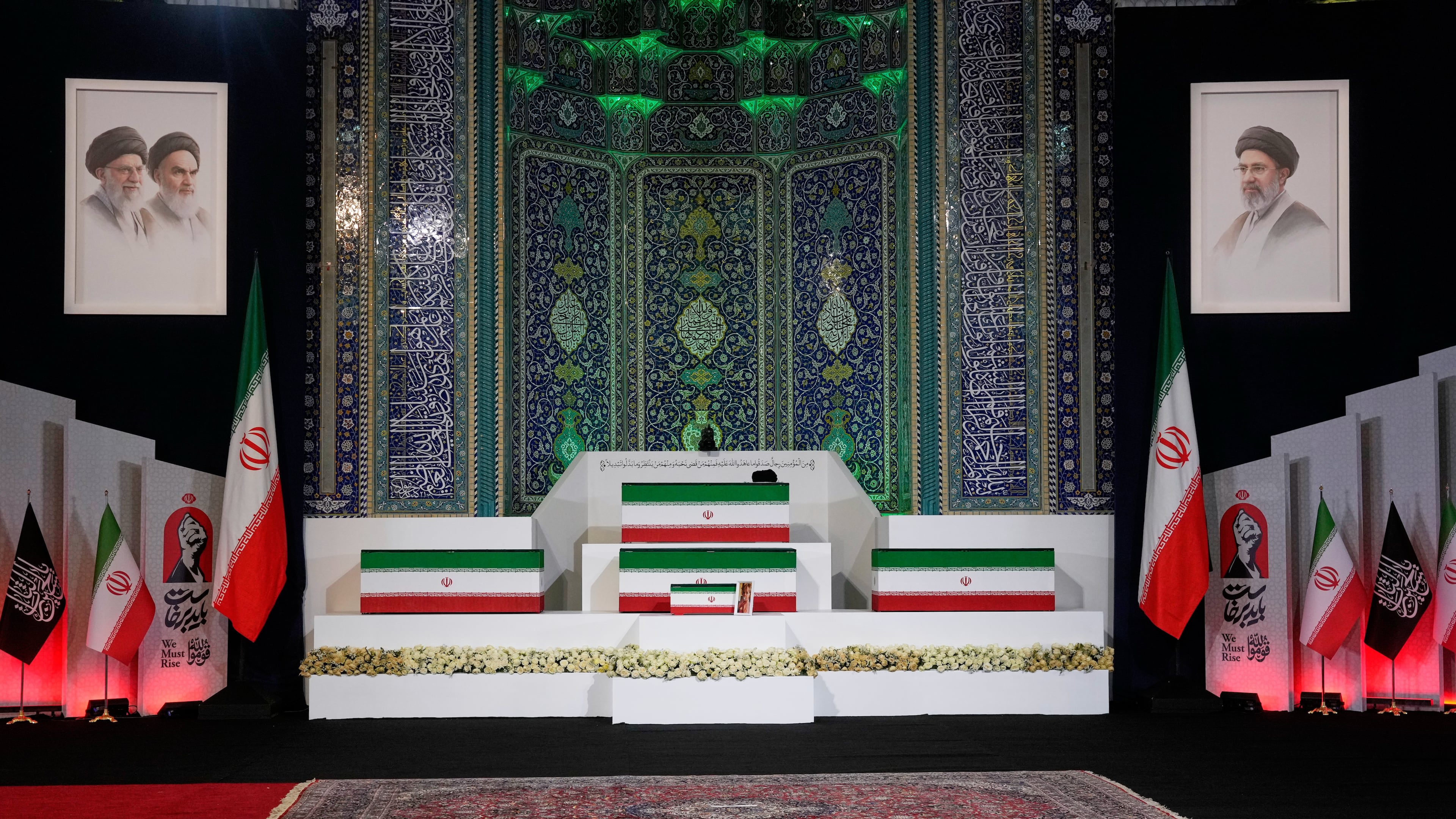 The coffins of slain Iranian Supreme Leader Ayatollah Ali Khamenei, center on top, and members of his family are displayed ahead of the dayslong funeral ceremonies at the Imam Khomeini Mosalla Grand Mosque in Tehran, Iran, Friday, July 3, 2026. (AP Photo/Vahid Salemi)