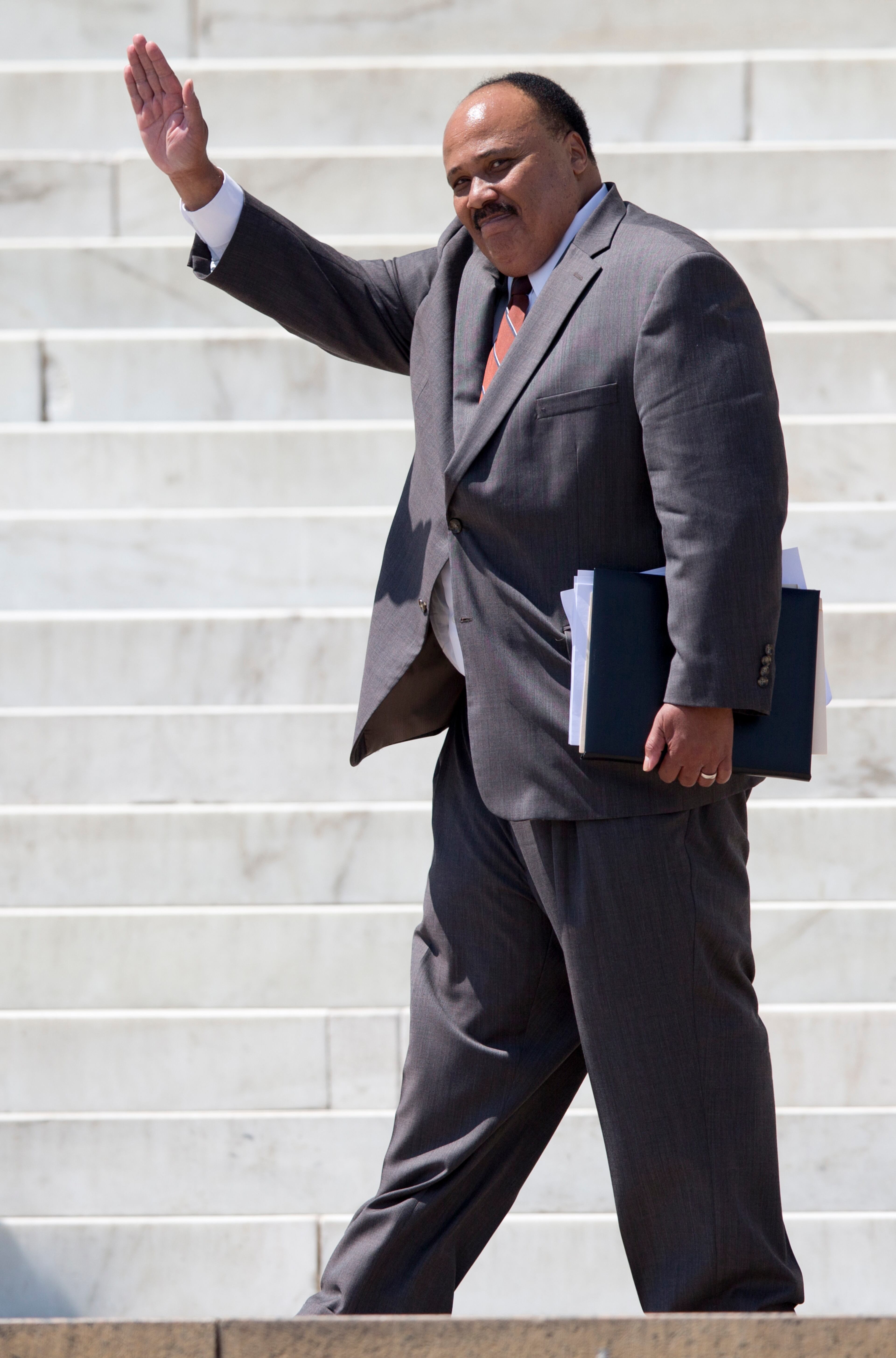 Martin Luther King III waves to the crowd after speaking during an event to commemorate the 50th anniversary of the 1963 March on Washington at the Lincoln Memorial, Saturday, Aug. 24, 2013, in Washington. (AP Photo/Carolyn Kaster)