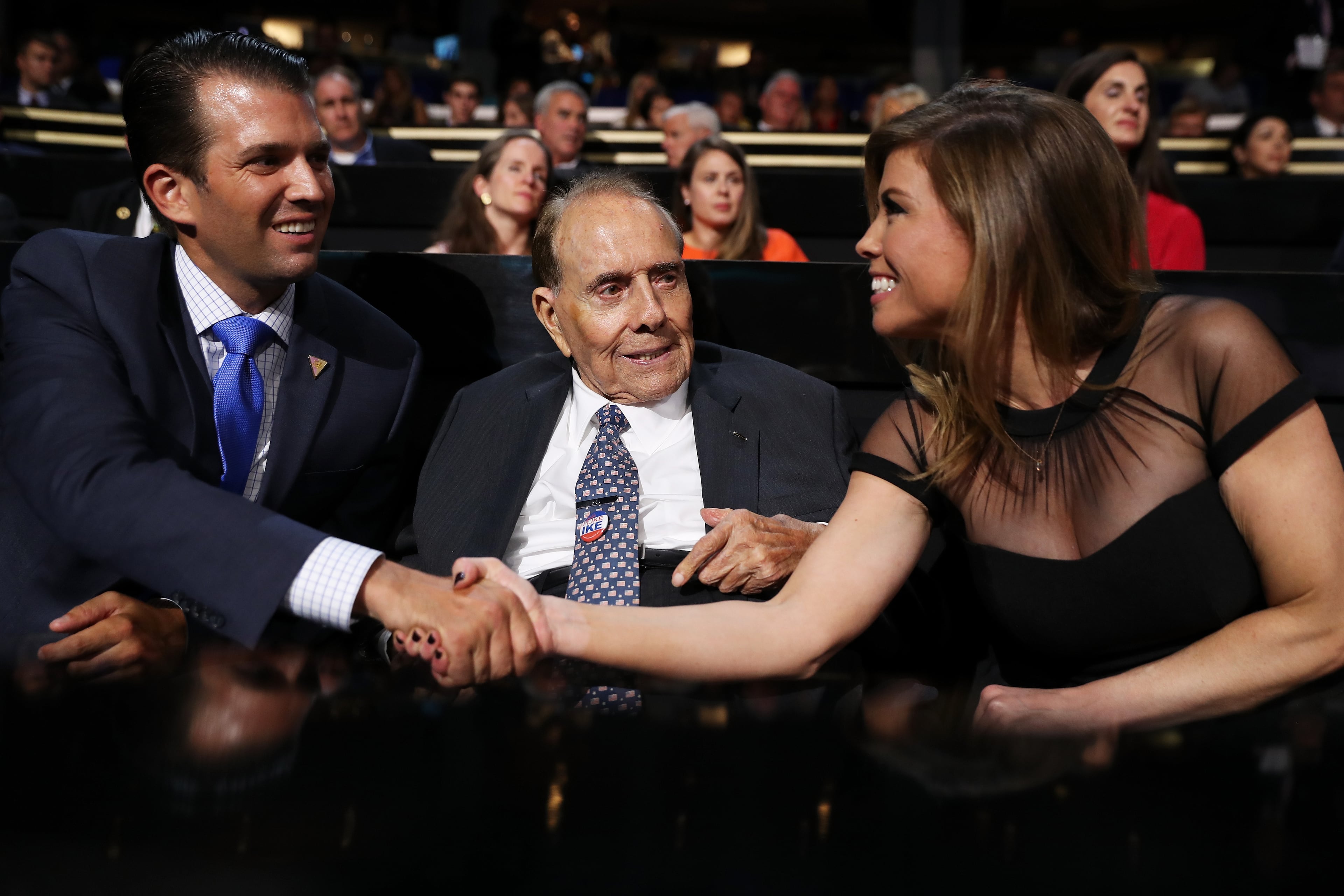 World War II veteran and former Sen. Bob Dole (R-KS) (C) along with Donald Trump Jr. (L) shake hands with a guest during the first day of the Republican National Convention on July 18, 2016 at the Quicken Loans Arena in Cleveland, Ohio. An estimated 50,000 people are expected in Cleveland, including hundreds of protesters and members of the media. The four-day Republican National Convention kicks off on July 18. (Photo by John Moore/Getty Images)