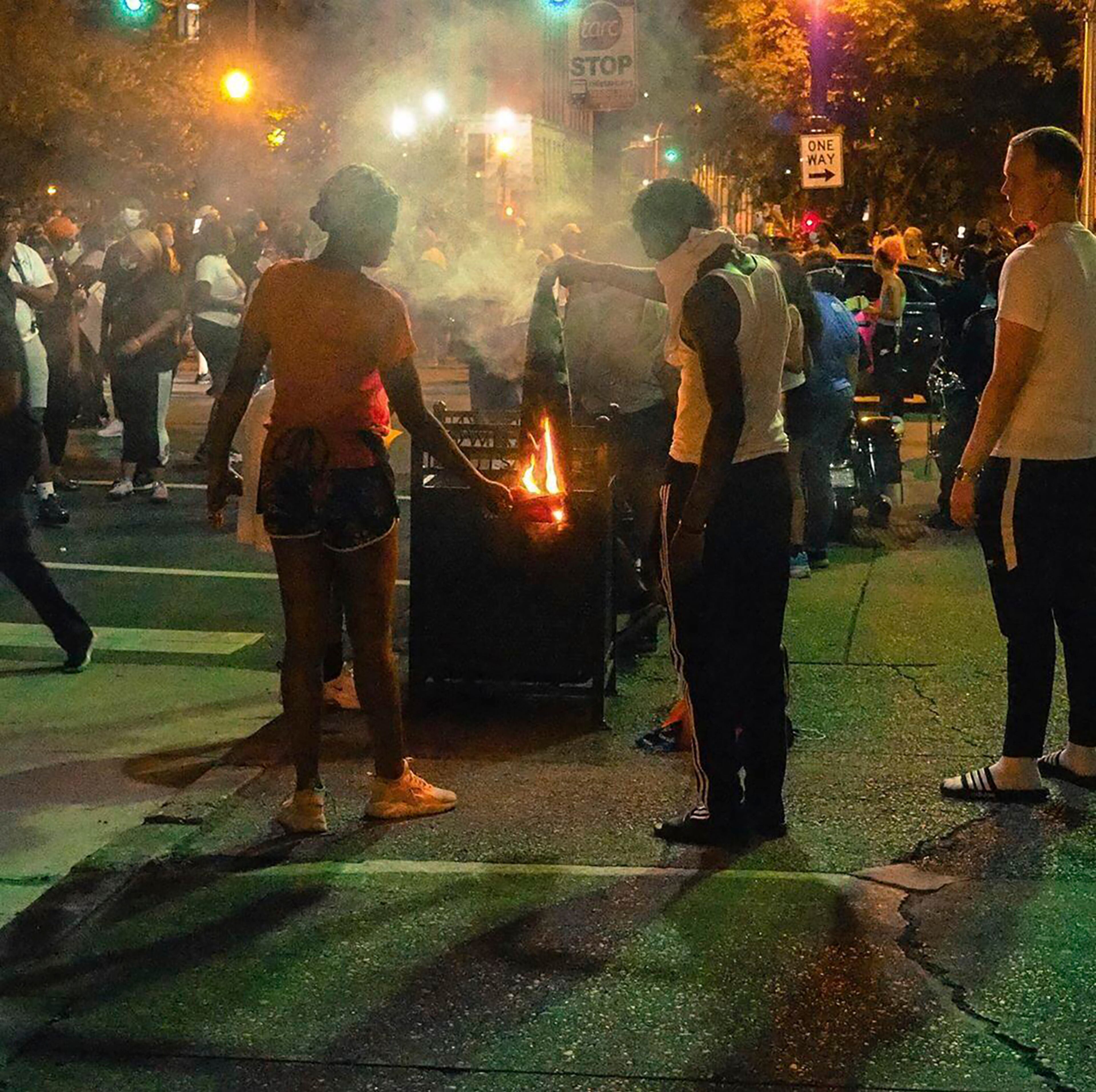 In this photo provided by the Instagram account of @mckinley_moore, demonstrators protest the killing of Breonna Taylor, a black woman who reportedly was shot by police in her home in March.