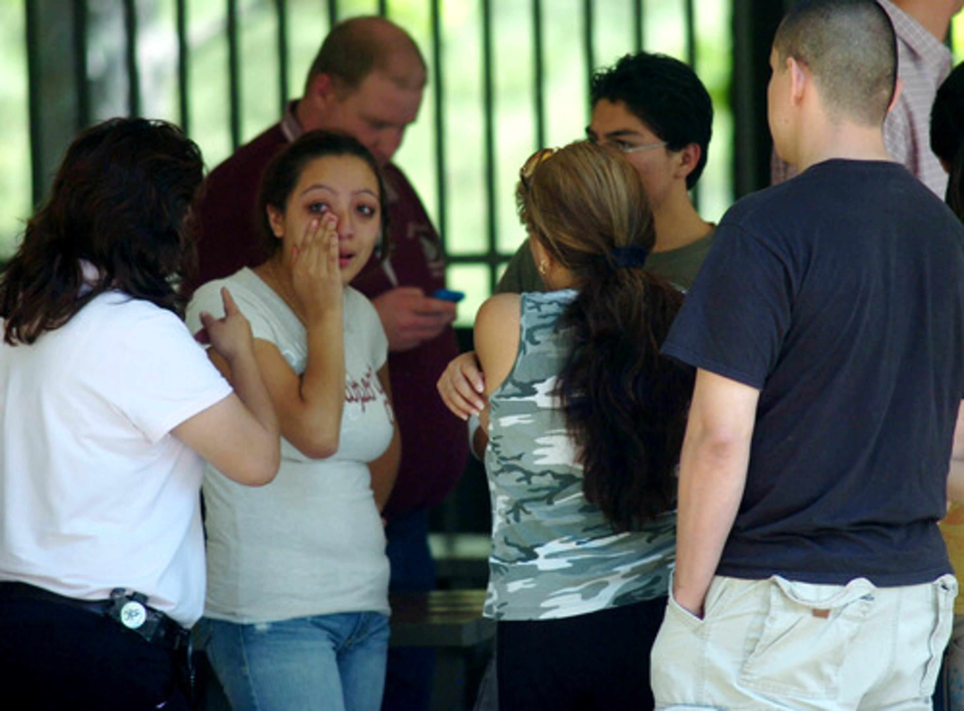 Authorities declined to release the victims' names. A group of people mourning the deaths gathered at the park.