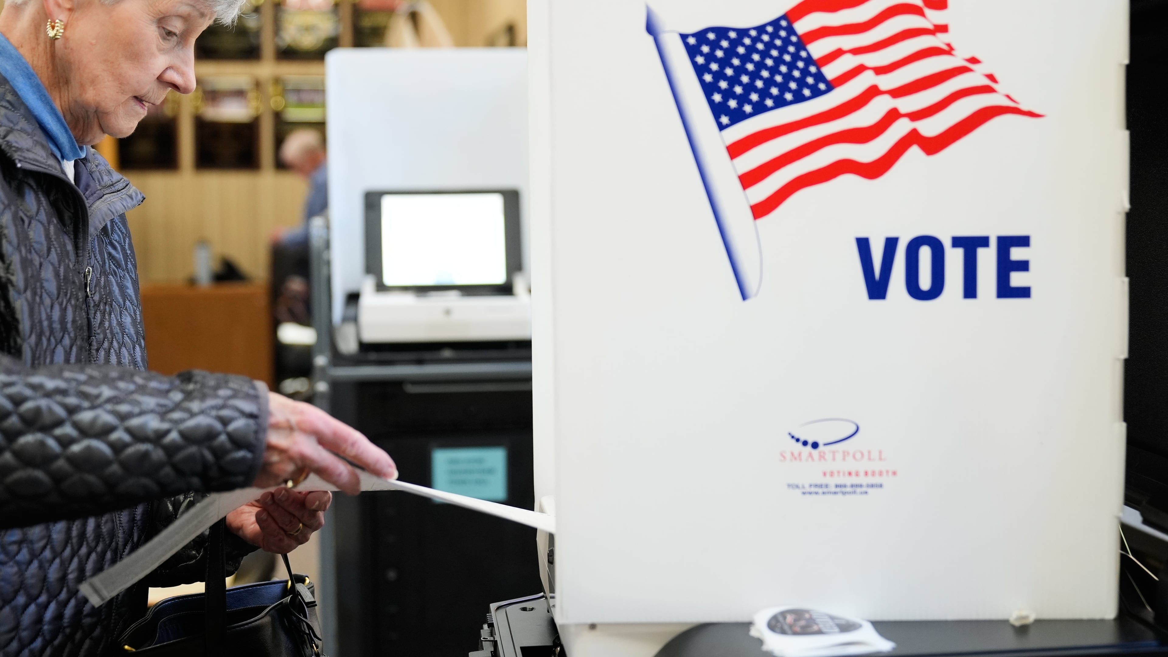 A woman feeds her ballot into a scanning machine at an early voting site in Haverstraw, N.Y., Monday, Oct. 26, 2026. (AP Photo/Seth Wenig)