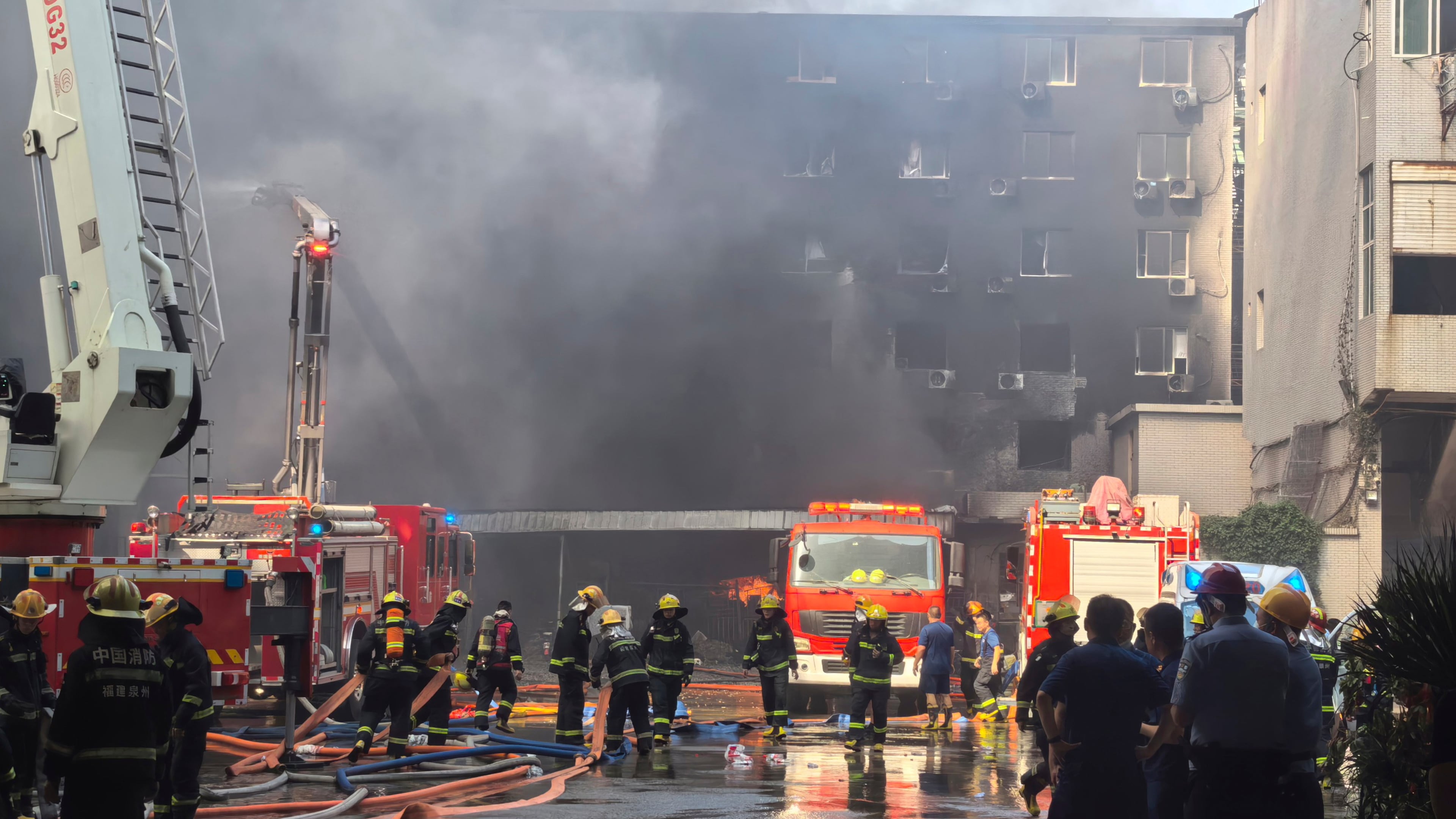 In this photo released by Xinhua News Agency, firefighters at the scene of a footwear factory fire in Jiangtou village, Chendai township of Jinjiang city, southeastern China's Fujian province, Thursday, July 9, 2026. (Zheng Liang/Xinhua via AP)