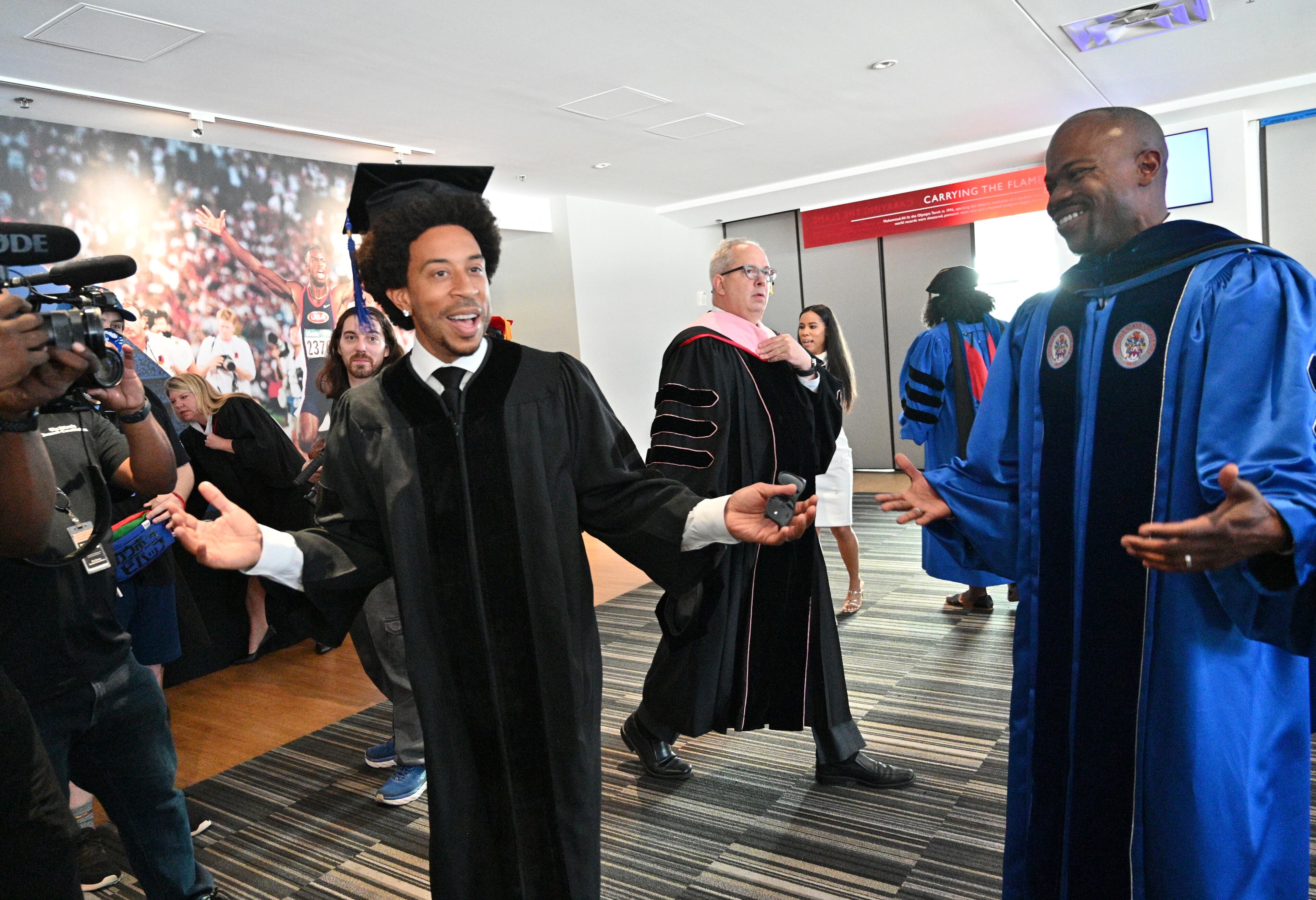 May 4 2022 Atlanta - Rapper and actor Chris “Ludacris” Bridges and Georgia State's president M. Brian Blake share a smile after getting their robes before GSU’s Master’s commencement ceremony at Center Parc Stadium on Wednesday, May 4, 2022. Georgia State University awarded Chris “Ludacris” Bridges an honorary degree at Master’s commencement at Center Parc Stadium. (Hyosub Shin / Hyosub.Shin@ajc.com)