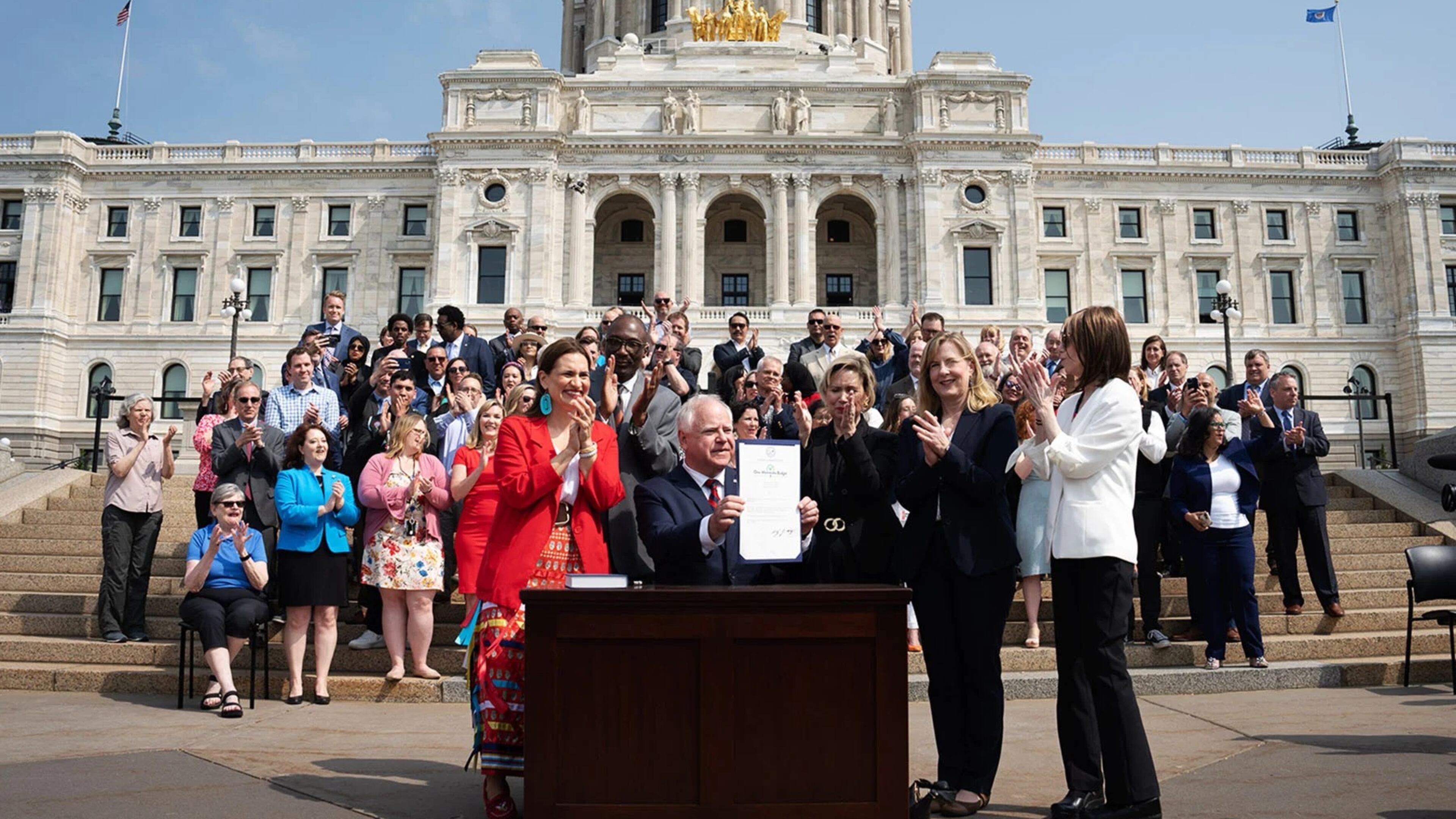 Gov. Tim Walz is seen at a ceremonial budget bill-signing party on the Minnesota State Capitol steps. (GLEN STUBBE/STAR TRIBUNE/GETTY IMAGES)