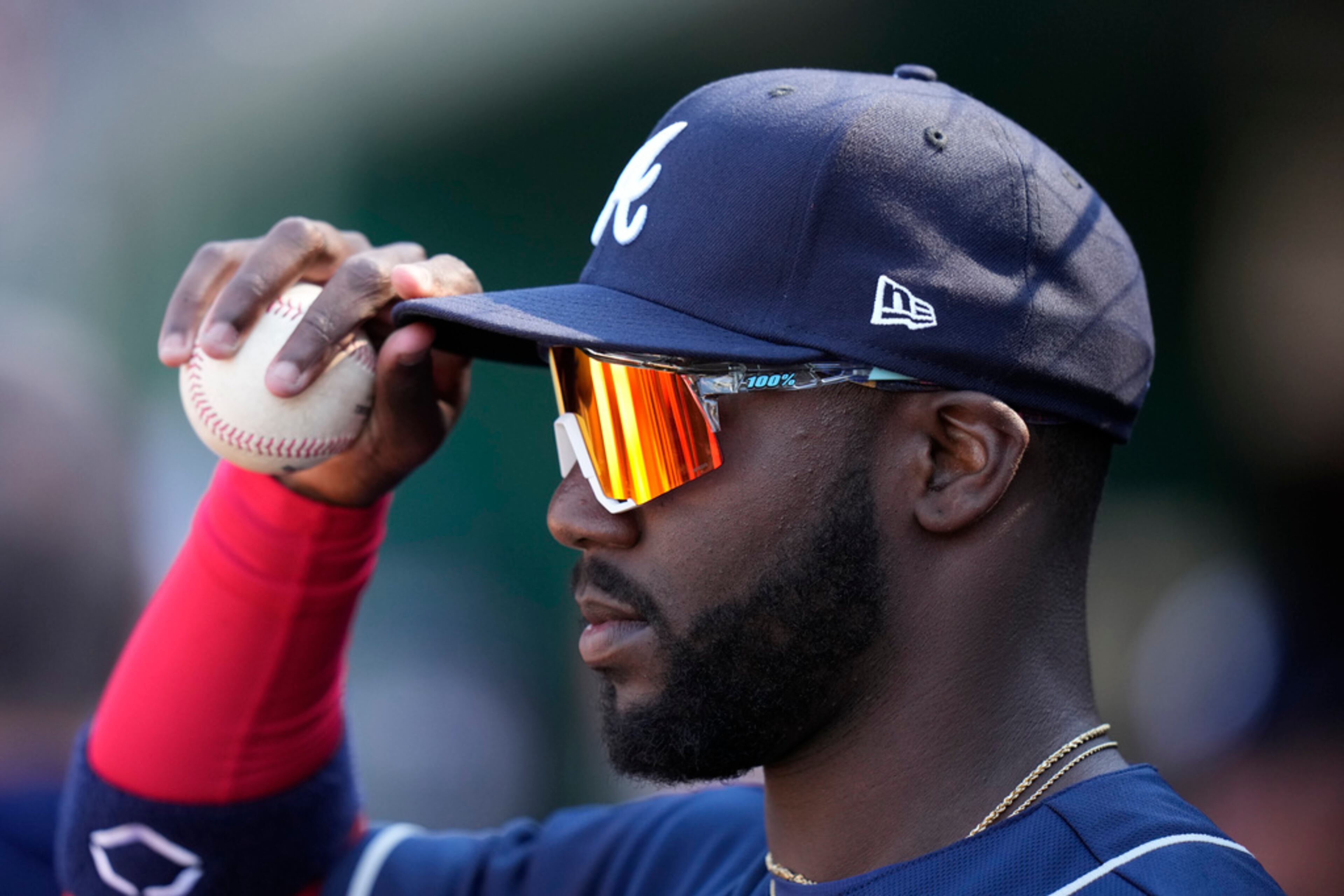 Atlanta Braves' Michael Harris II adjusts his hat while standing in the dugout during the eighth inning of an opening day baseball game against the Washington Nationals at Nationals Park, Thursday, March 30, 2023, in Washington. (AP Photo/Alex Brandon)