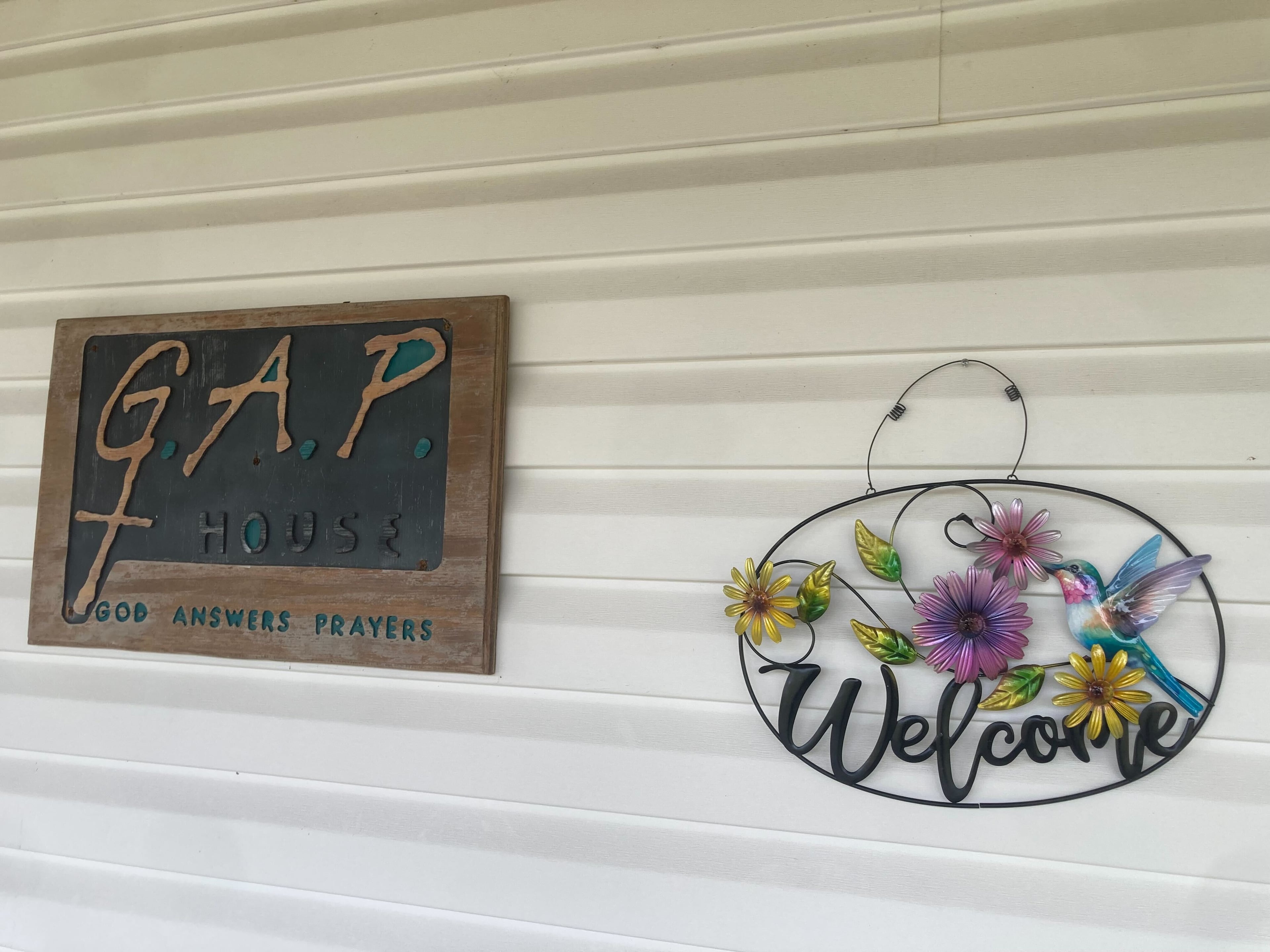 A "Welcome" sign at the entrance of a building on the rural campus of GAP House Ministries in Bryan County, Georgia on April 30, 2026. Flames from the Highway 82 wildfire came within a couple hundred yards of the nonprofit's buildings, forcing residents to evacuate. (Adam Van Brimmer/AJC)