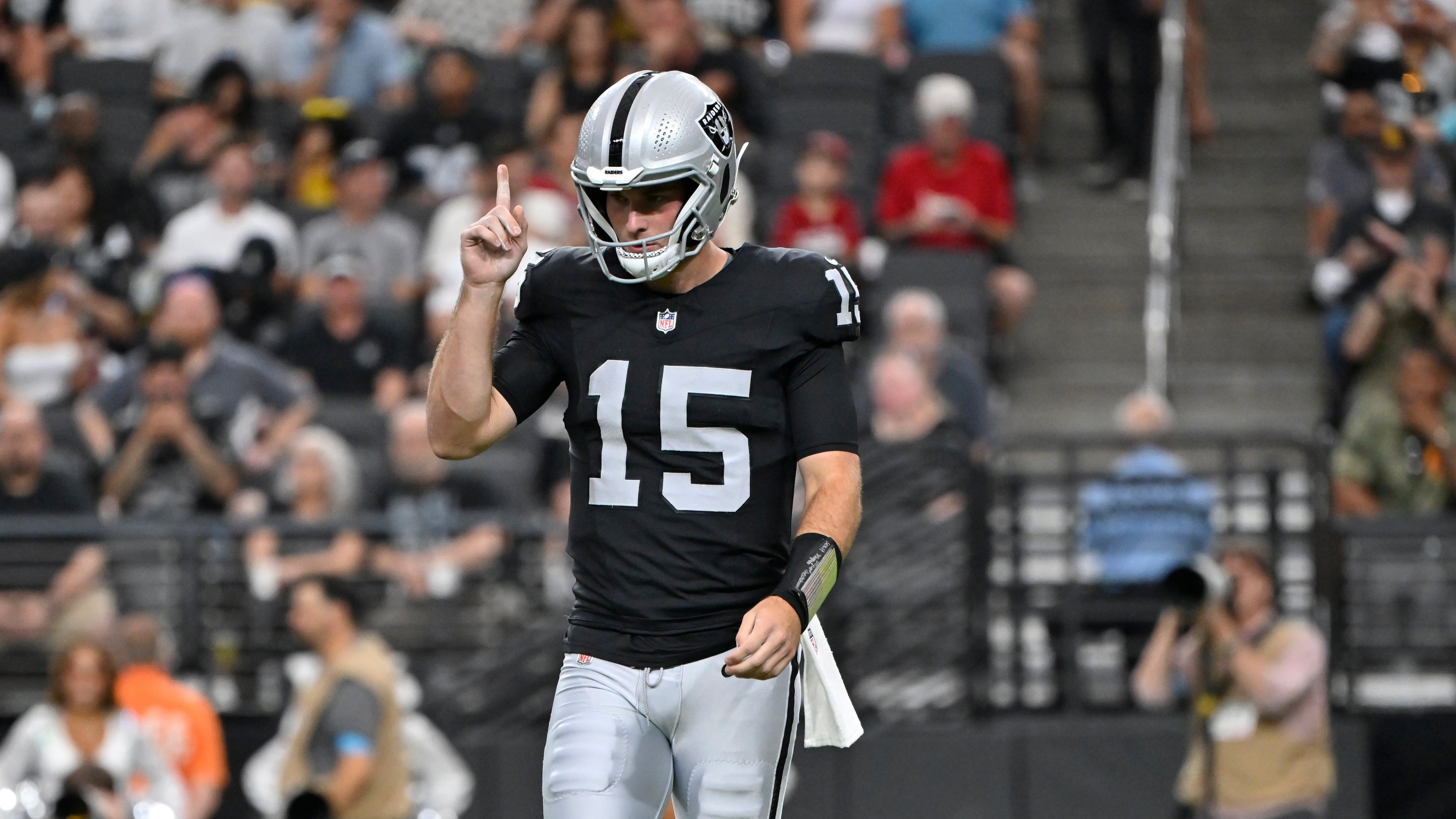 Las Vegas Raiders quarterback Fernando Mendoza (15) pauses on the field during the first half of a preseason NFL football game against the Arizona Cardinals, Thursday, Aug. 13, 2026, in Las Vegas. (AP Photo/David Becker)