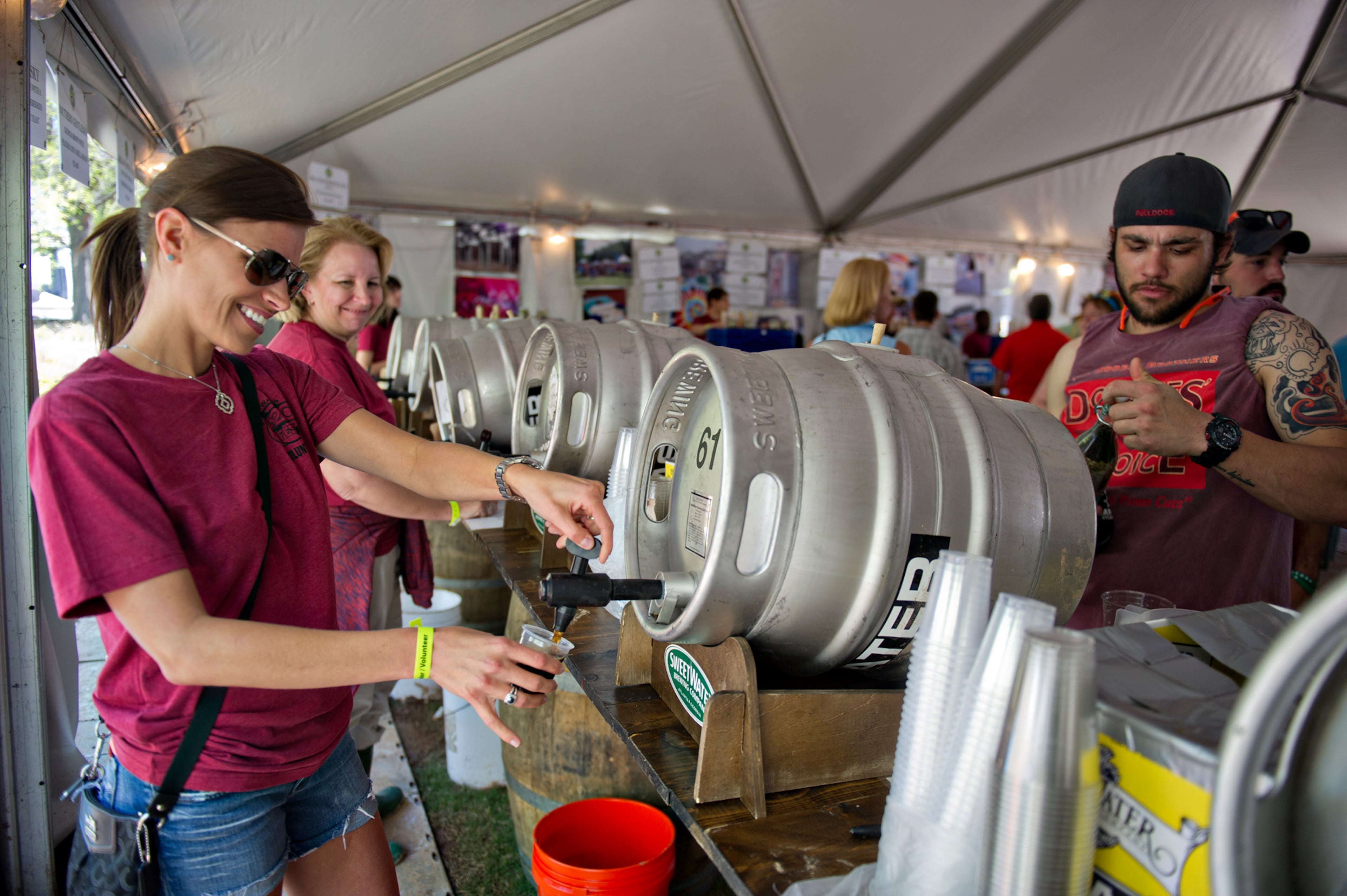Tanya Morea (left) pours John Hurd a beer during the Sweetwater 420 Festival at Centennial Olympic Park on Sunday, April 20, 2014.