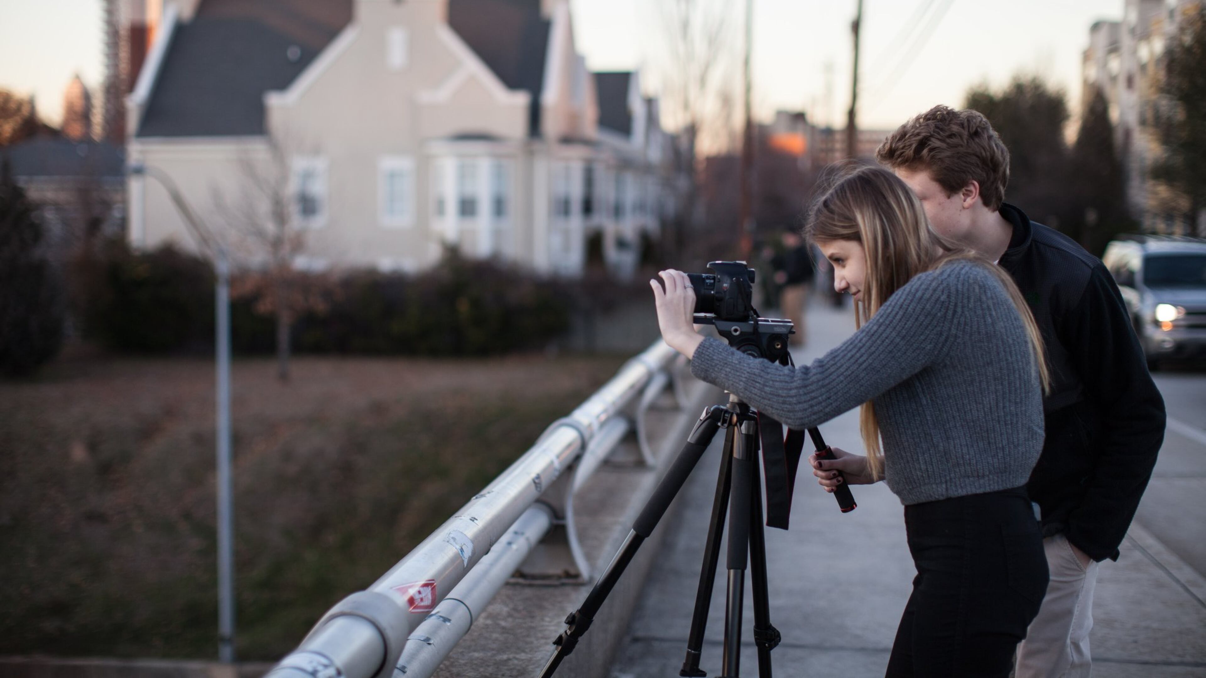 Sydney Lord, left, and her brother Sam Lord record video footage of the Atlanta skyline from the Jackson Street Bridge at sunset, Wednesday, Jan. 28, 2015, in Atlanta. Experienced local photographers may consider the view from the bridge a little cliche, but that doesn’t stop them from returning to it for a better shot. (SPECIAL/BRANDEN CAMP)