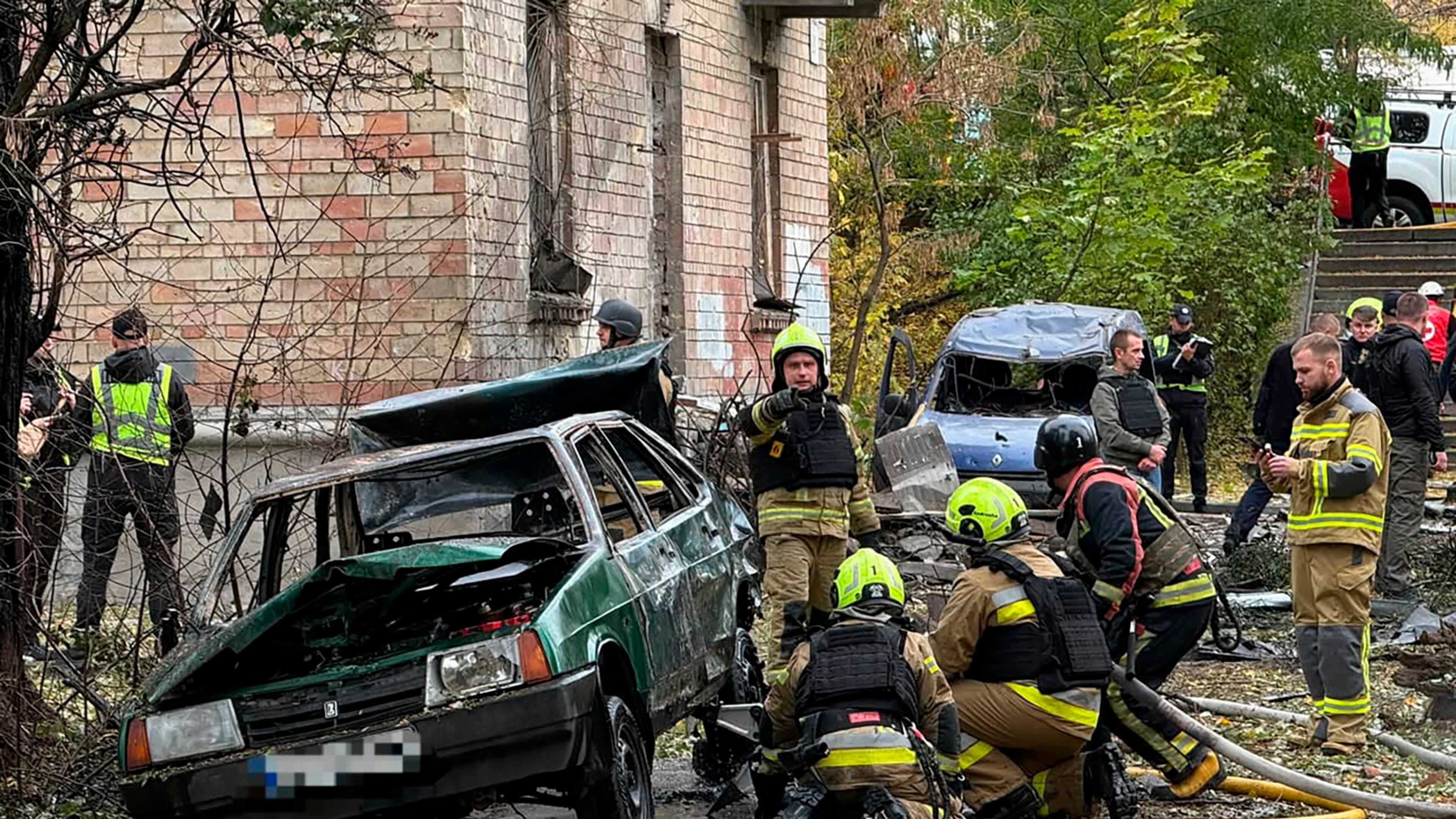 In this photo provided by the Ukrainian Emergency Service, emergency services personnel work in residential neiboorhud following a Russian air attack in Kyiv, Ukraine, Thursday, Oct. 15, 2026. (Ukrainian Emergency Service via AP)
