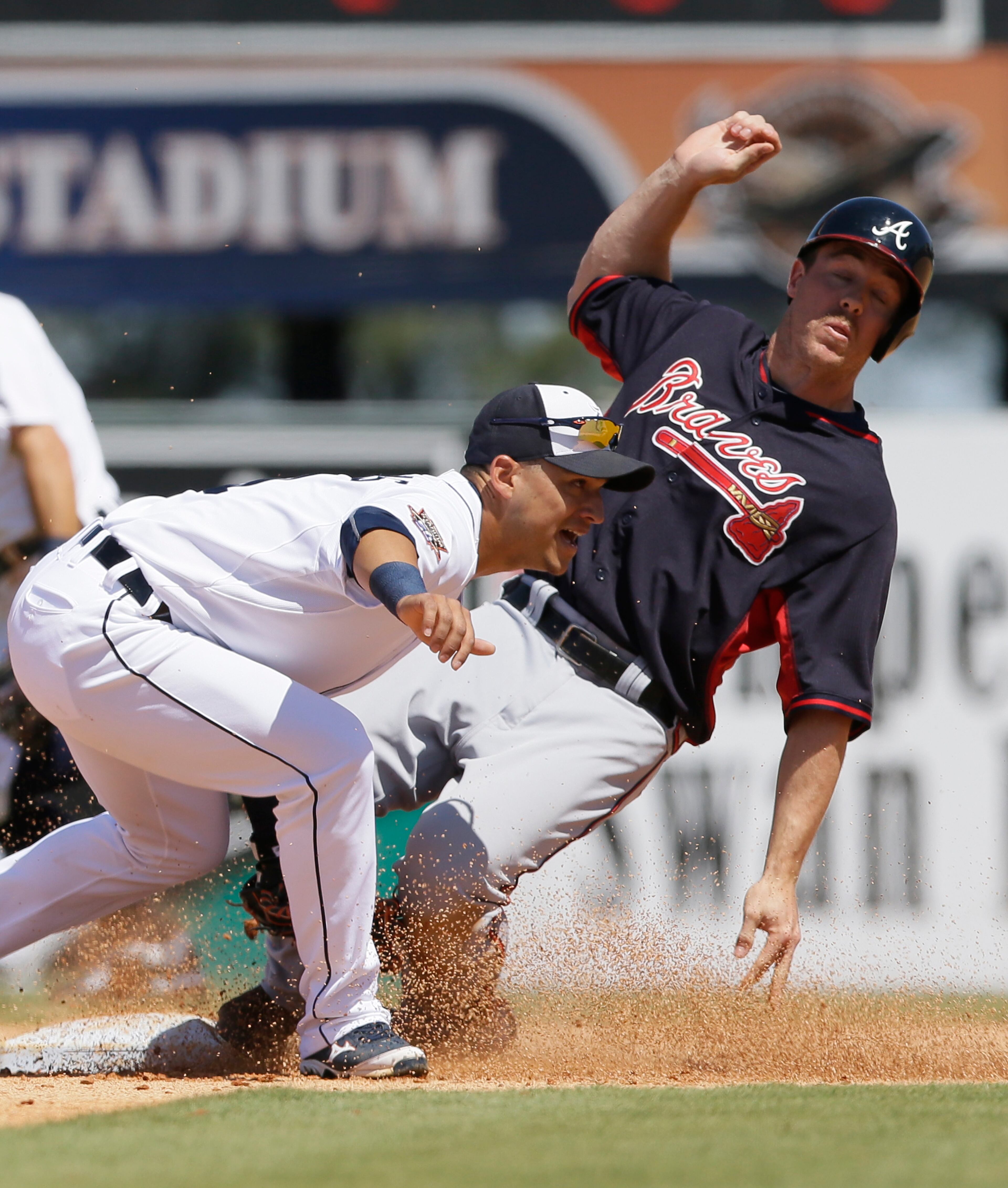 Atlanta Braves' Joe Benson is caught stealing second by Detroit Tigers shortstop Jose Iglesias during the sixth inning of a spring training exhibition baseball game in Lakeland, Fla., Monday, March 30, 2015. (AP Photo/Carlos Osorio)