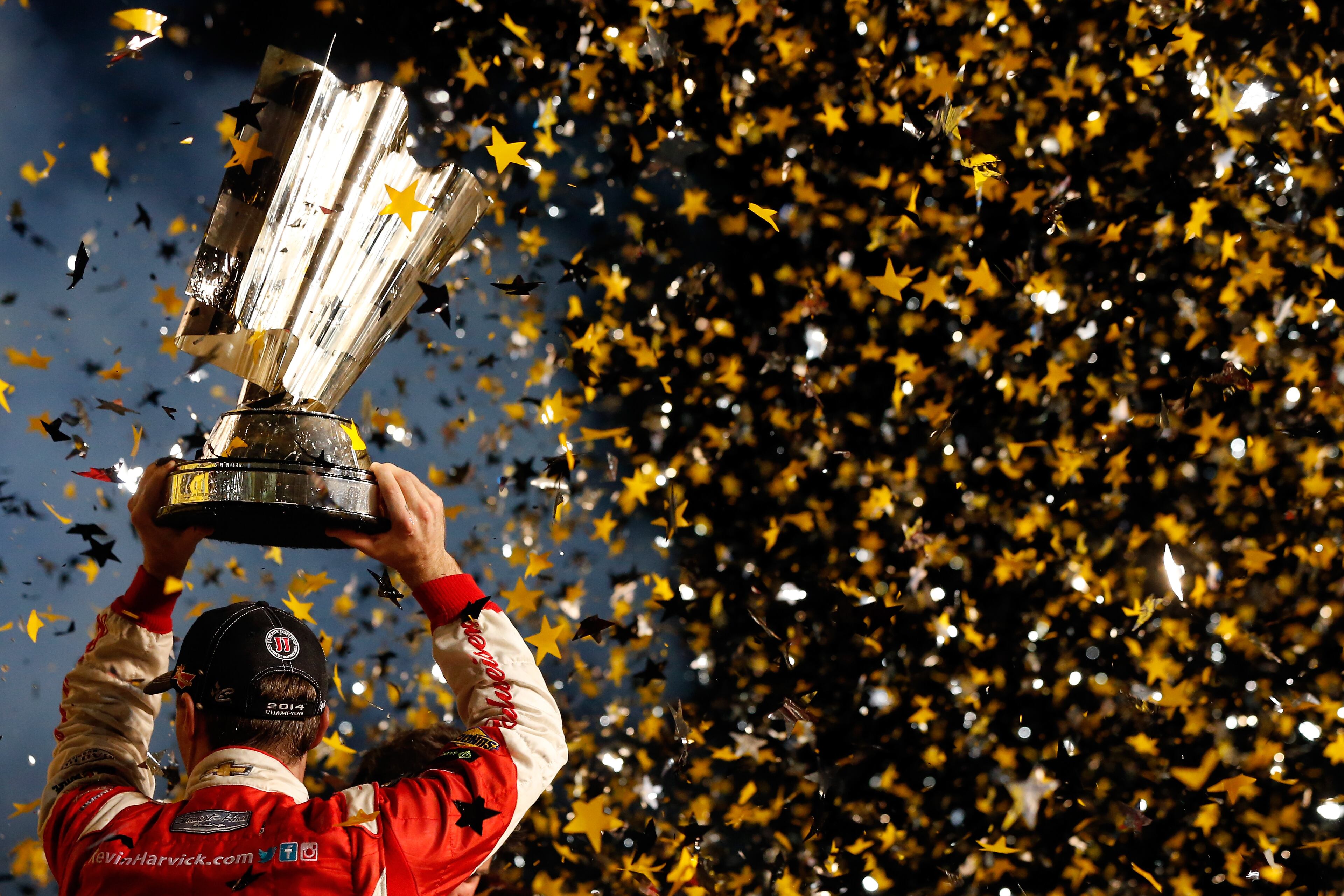 HOMESTEAD, FL - NOVEMBER 16: Kevin Harvick, driver of the #4 Budweiser Chevrolet, celebrates with the trophy in victory lane after winning during the NASCAR Sprint Cup Series Ford EcoBoost 400 at Homestead-Miami Speedway on November 16, 2014 in Homestead, Florida. (Photo by Sean Gardner/Getty Images)