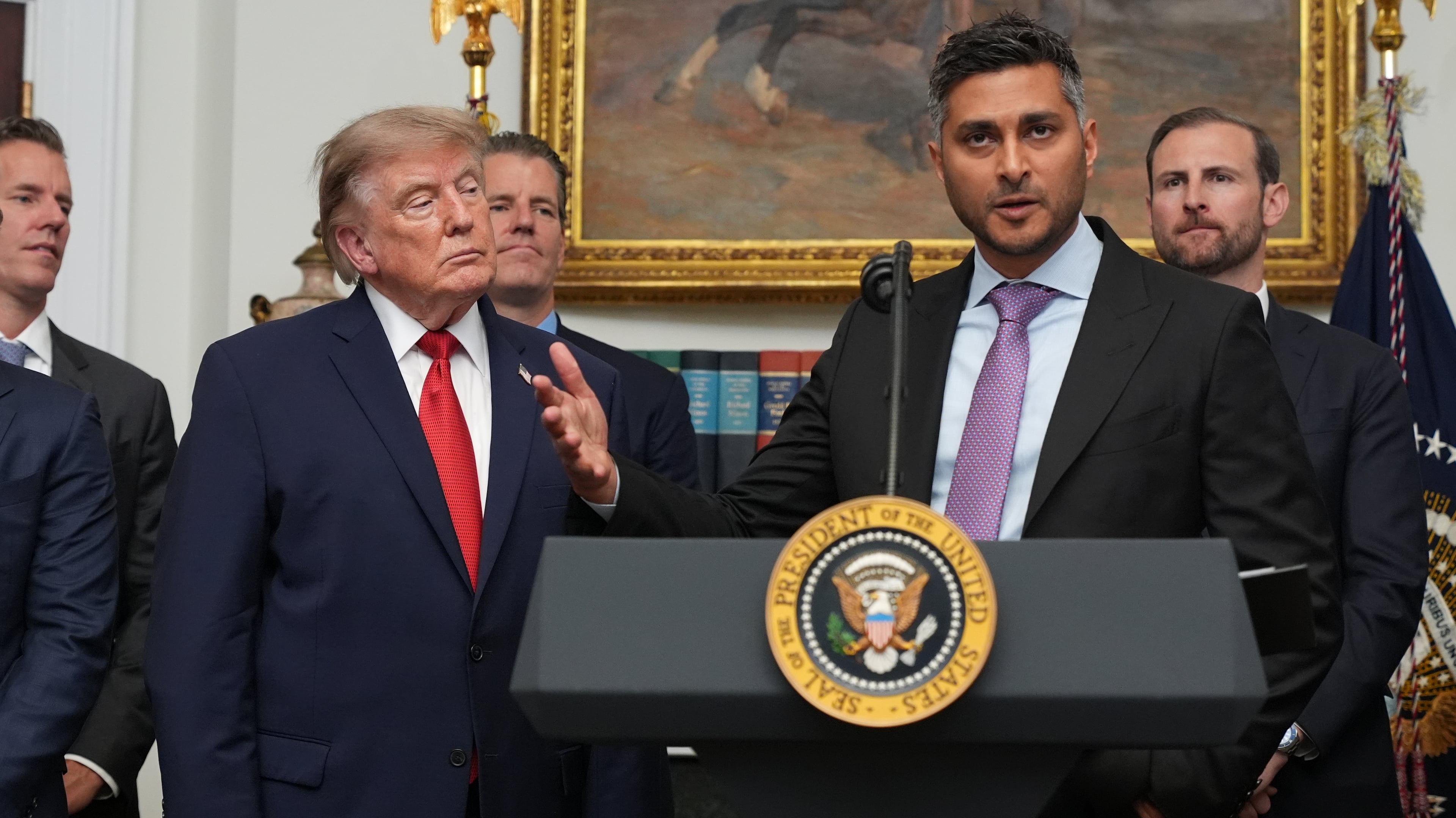 FILE - Kraken co-CEO Arjun Sethi speaks as President Donald Trump listens during a meeting with technology leaders in the Roosevelt Room of the White House, Aug. 19, 2026, in Washington. (AP Photo/Jacquelyn Martin, File)